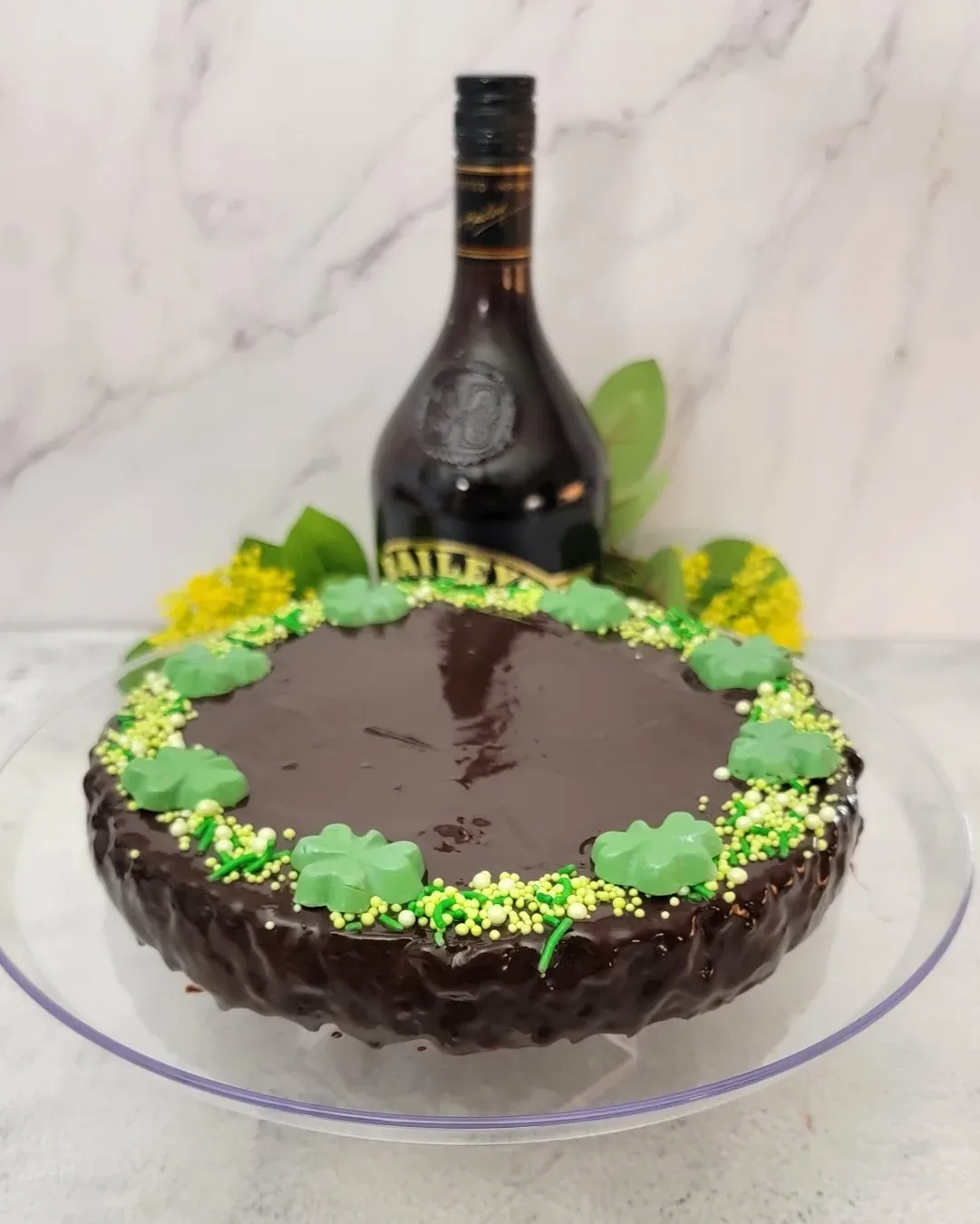 Baileys flourless chocolate cake on a serving platter decorated for St Patrick's day