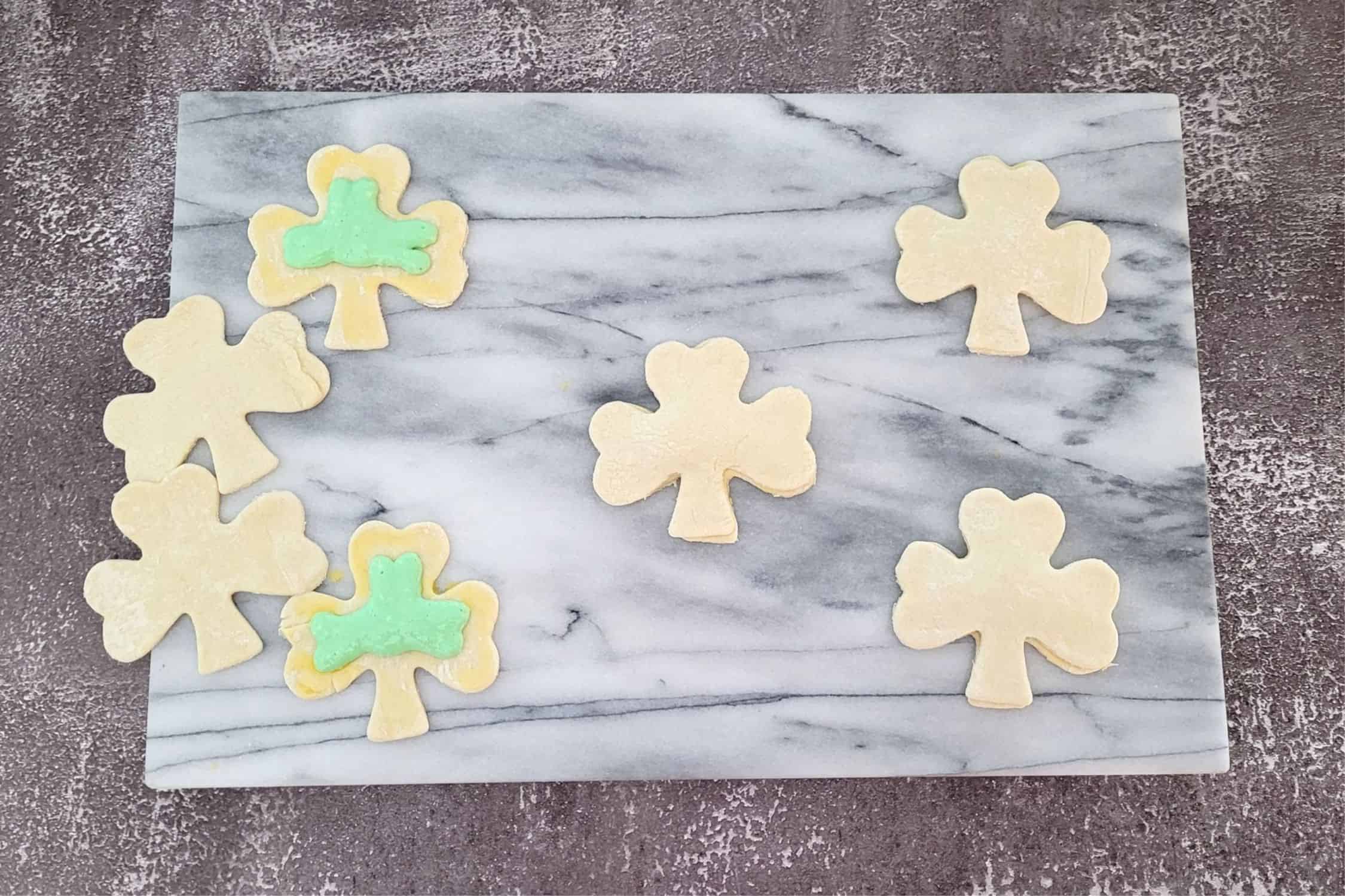 placing the top dough on each shamrock with filling