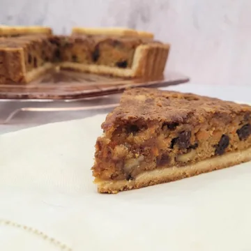 slice of carrot cake pie with full pie in the background