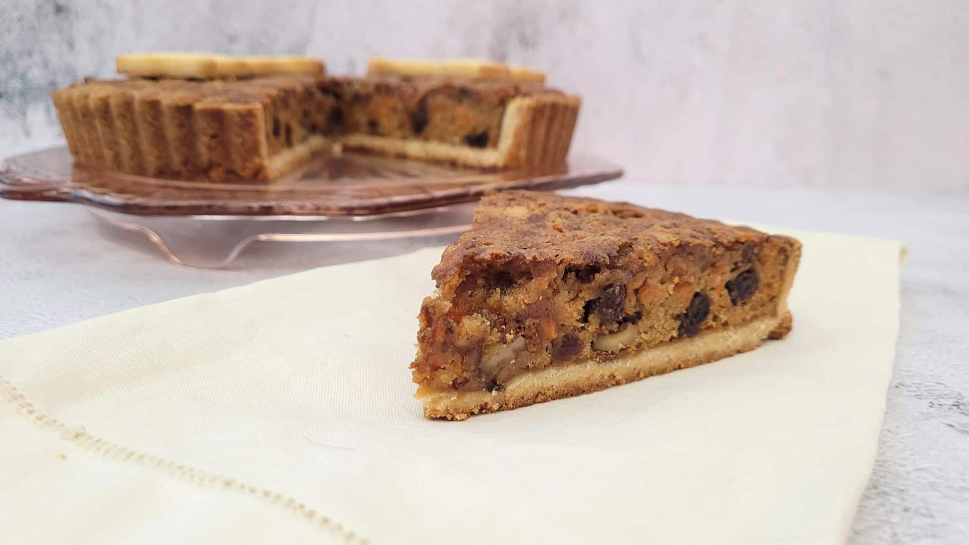 slice of carrot cake pie with full pie in the background