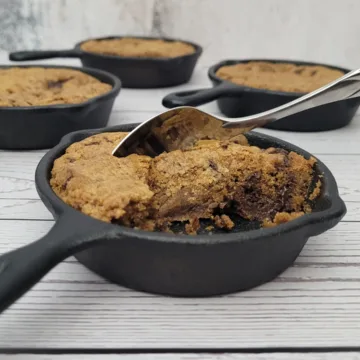 chocolate chip individual skillet cookie with a spoon in pan