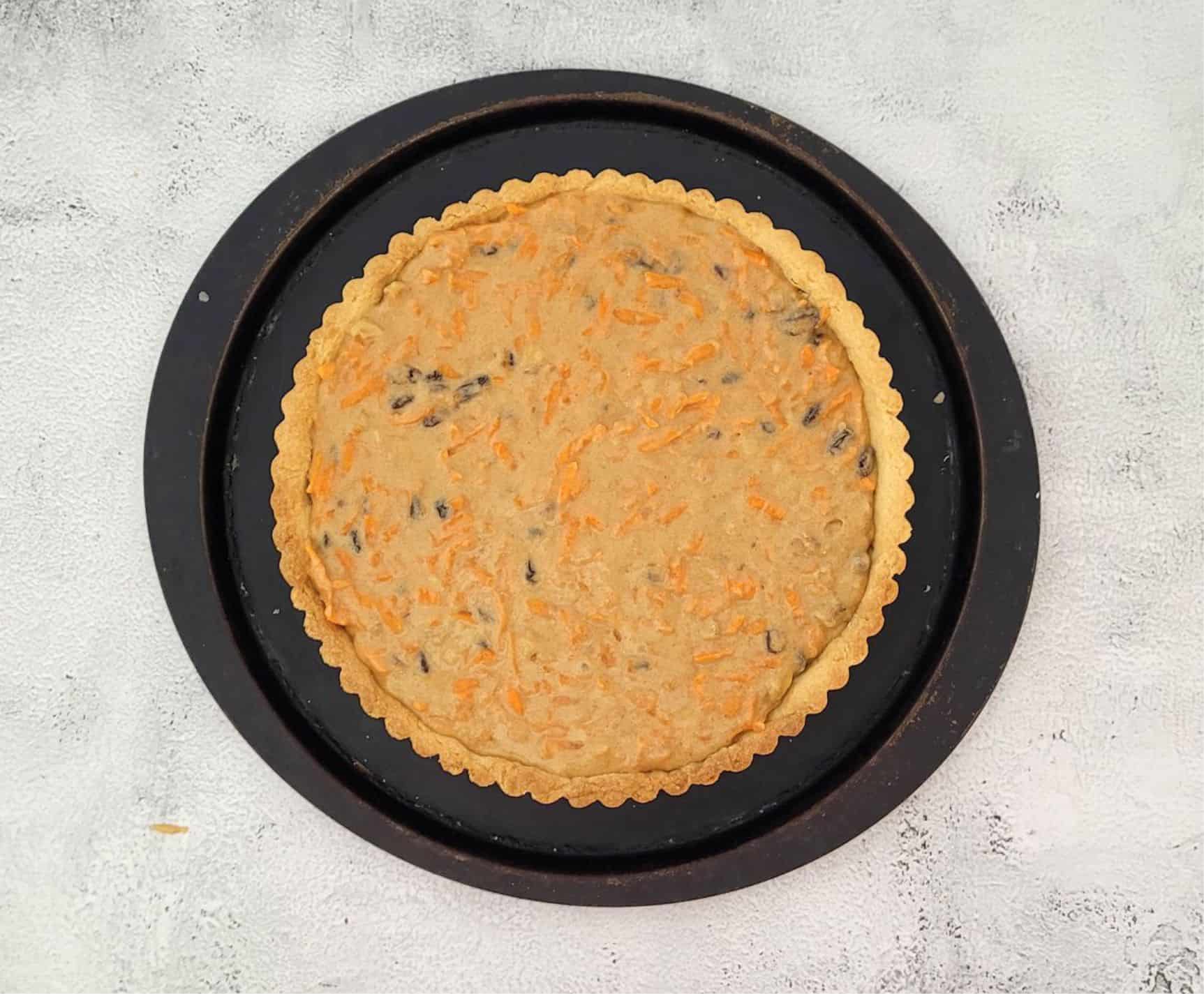 spread carrot pie filling into pie pan before baking