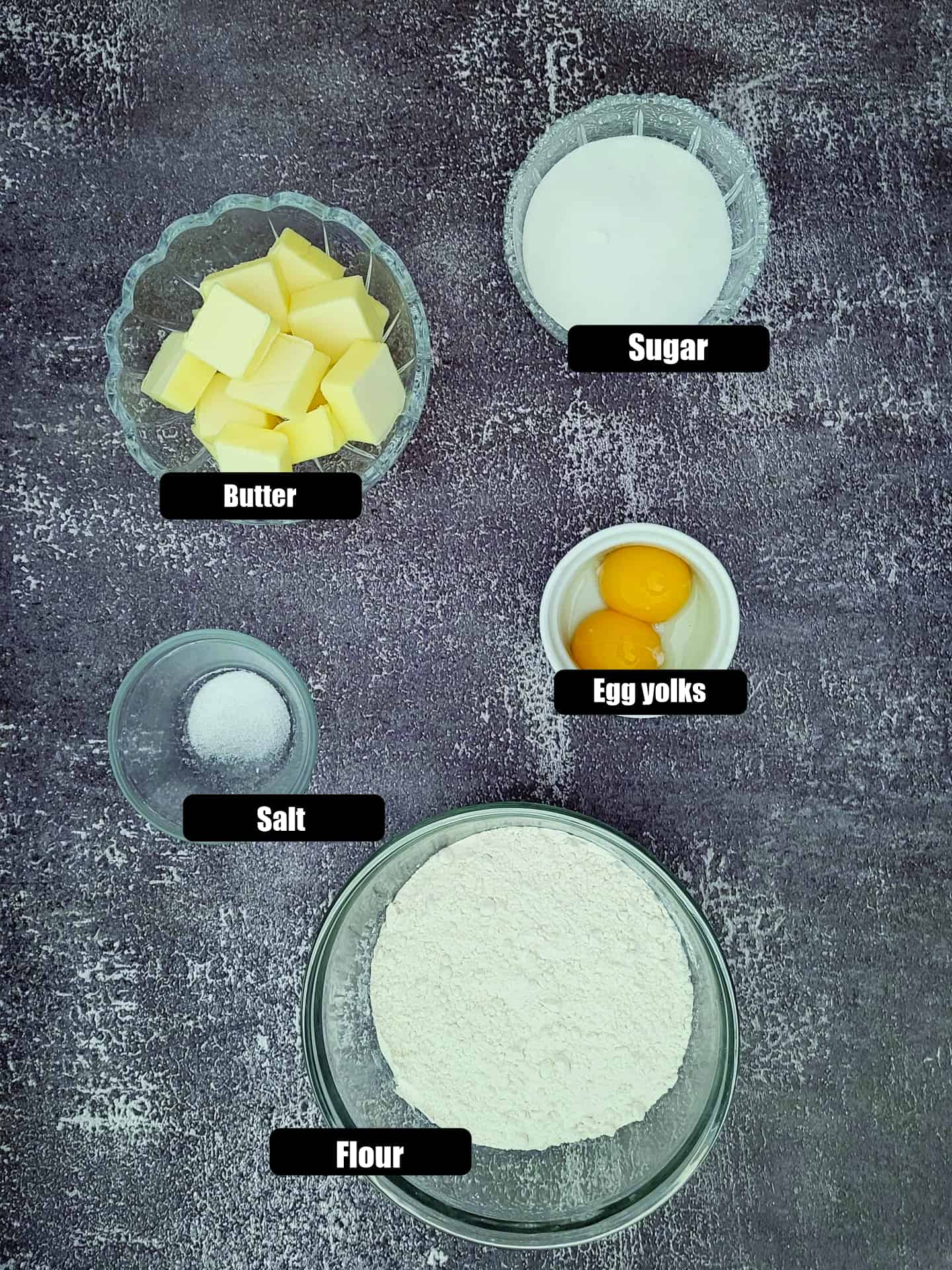ingredients needed to make sweet pie dough including flour, egg yolks, salt and butter