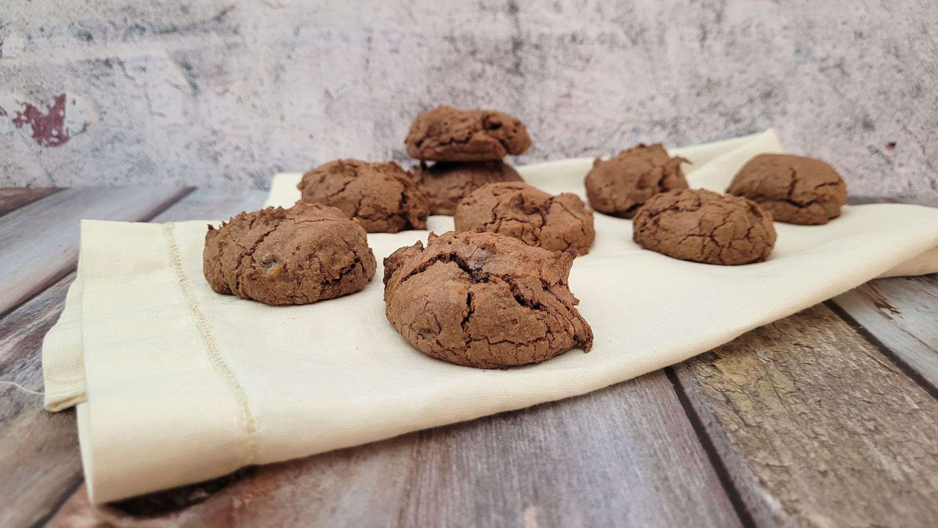 several gluten free chocolate sour cream cookies on a napkin
