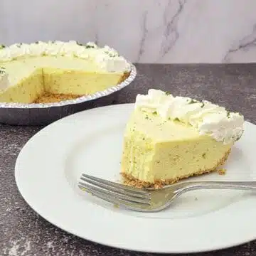 slice of no bake lime chiffon pie on a plate with remainder of pie in the background