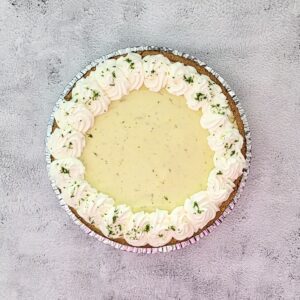 overhead view of a no bake lime chiffon pie with whipped cream swirls and lime zest