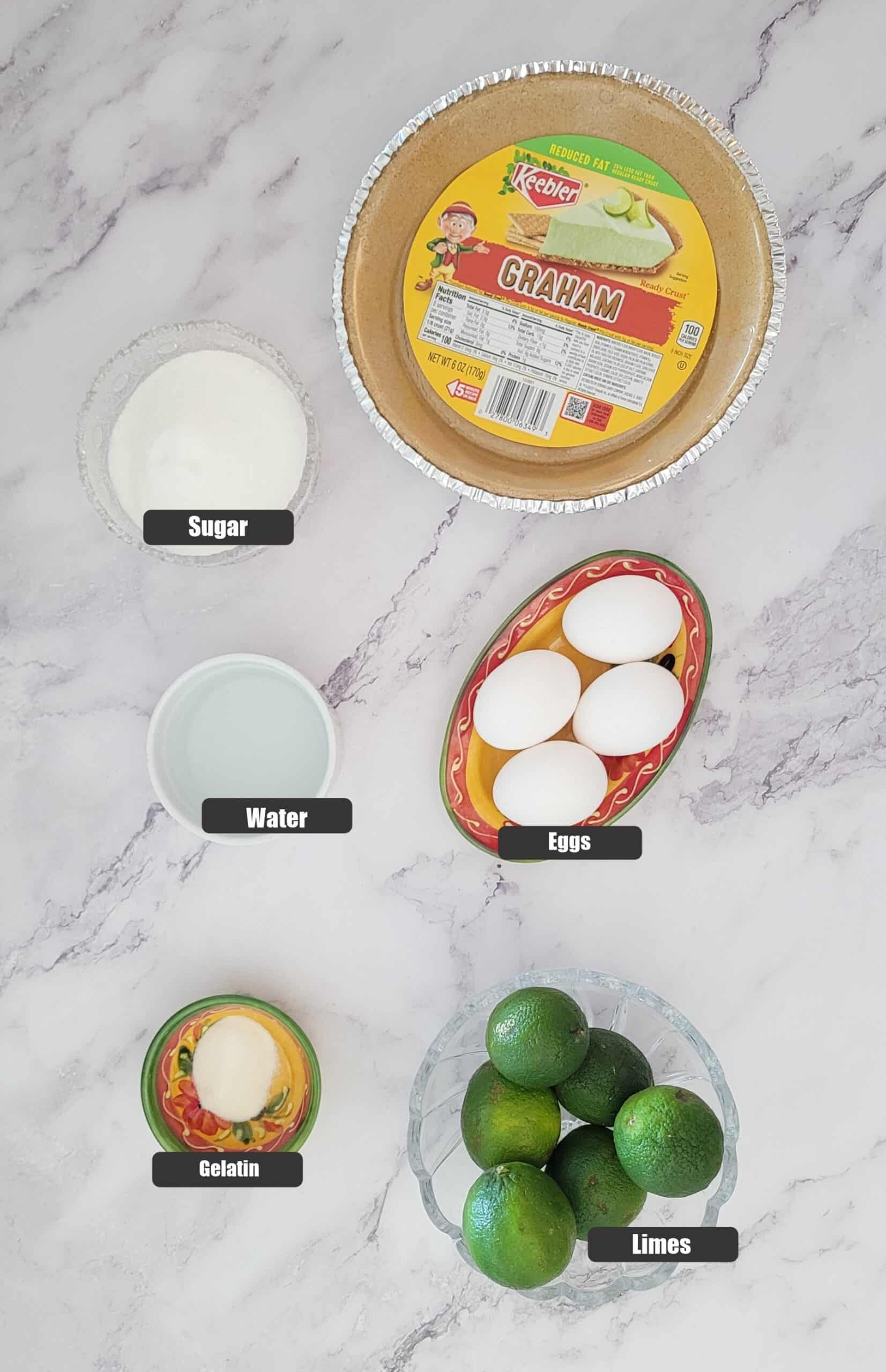 ingredients needed to make the lime chiffon pie including eggs, limes, water, sugar, gelatin and a pie crust