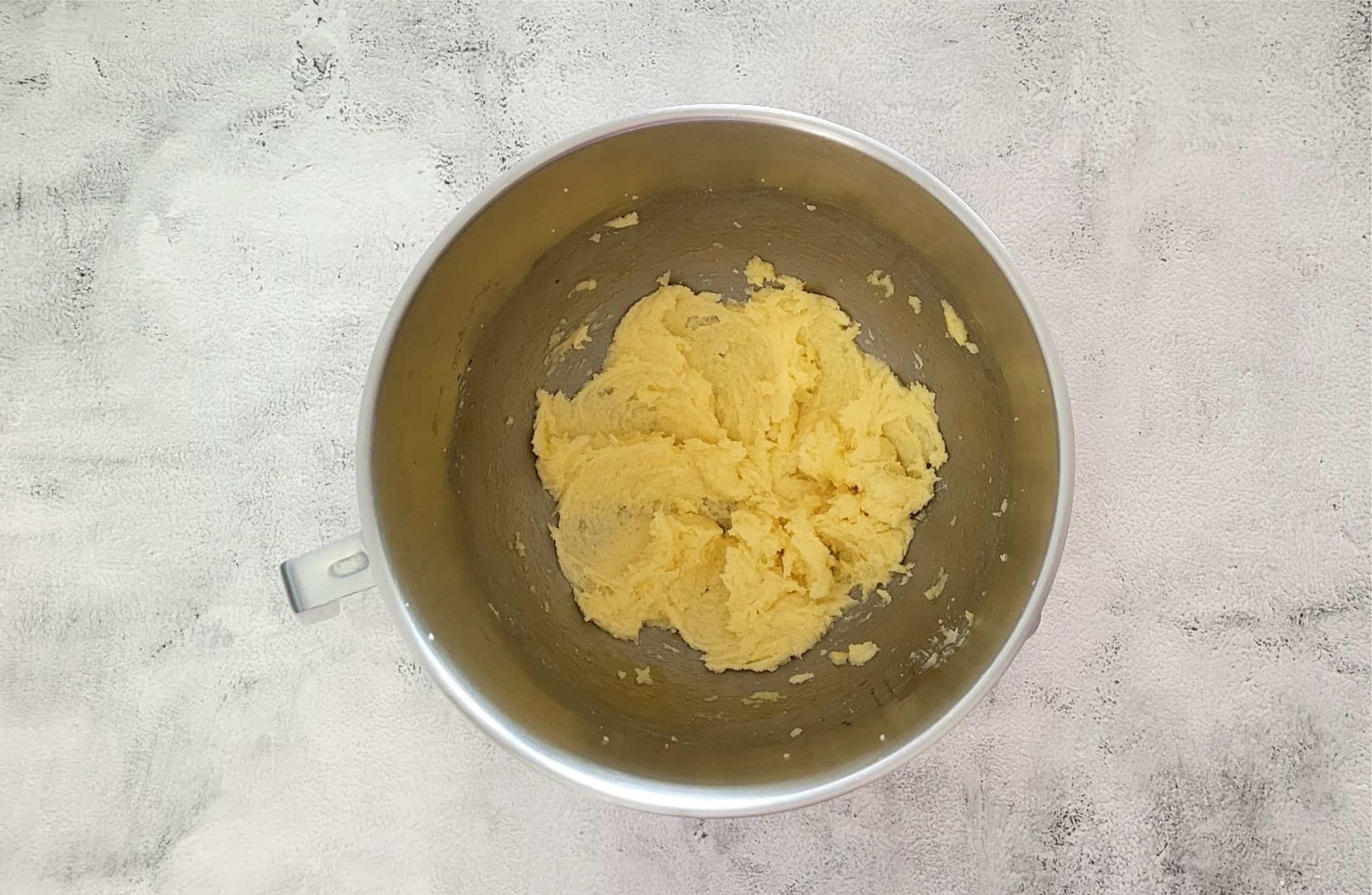 egg and vanilla added to mixing bowl to make cookie dough