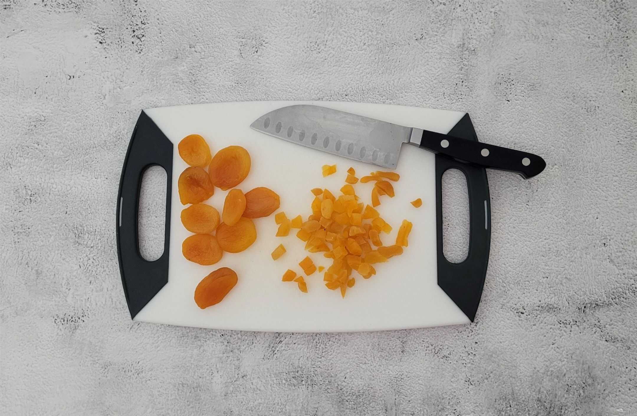 dried apricots chopped into small pieces on a cutting board