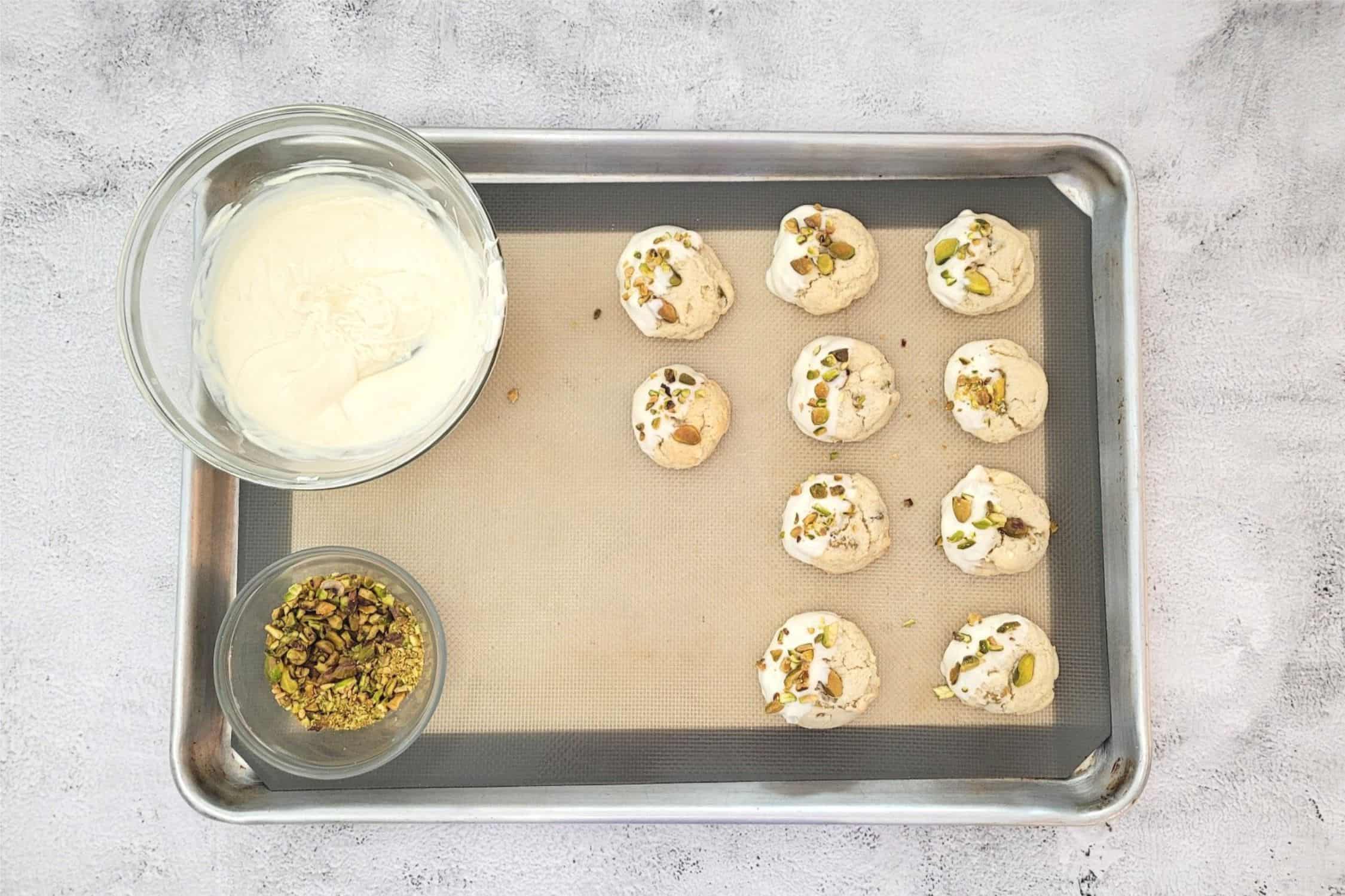 cookies dipped in white chocolate and spinkled with pistachio pieces