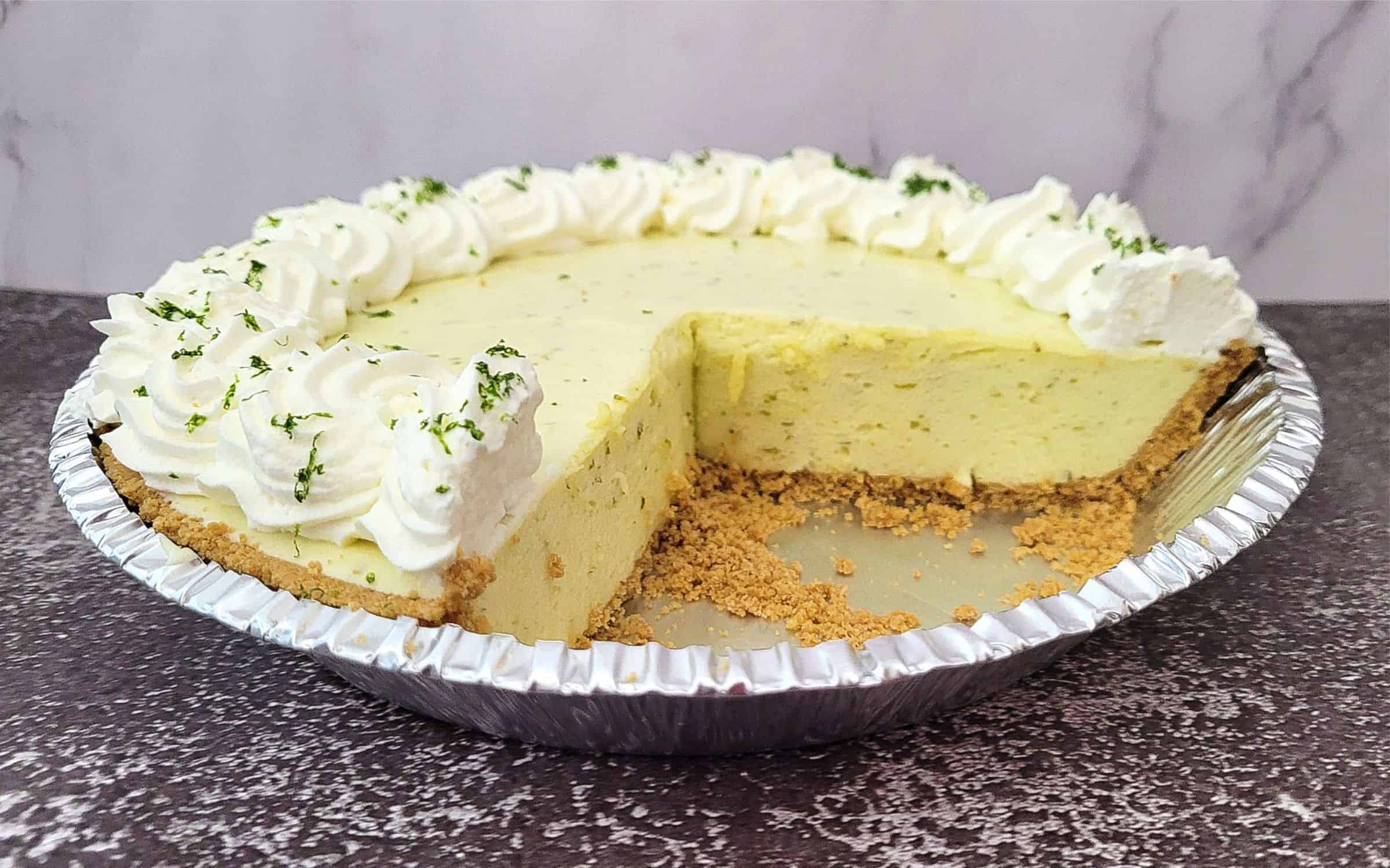 finished no bake lime chiffon pie with two slices removed from pan