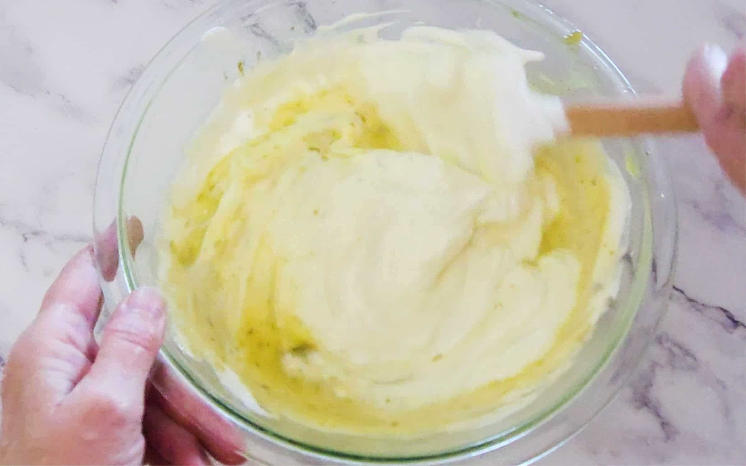 folding whipped egg whites into lime custard to make pie filling