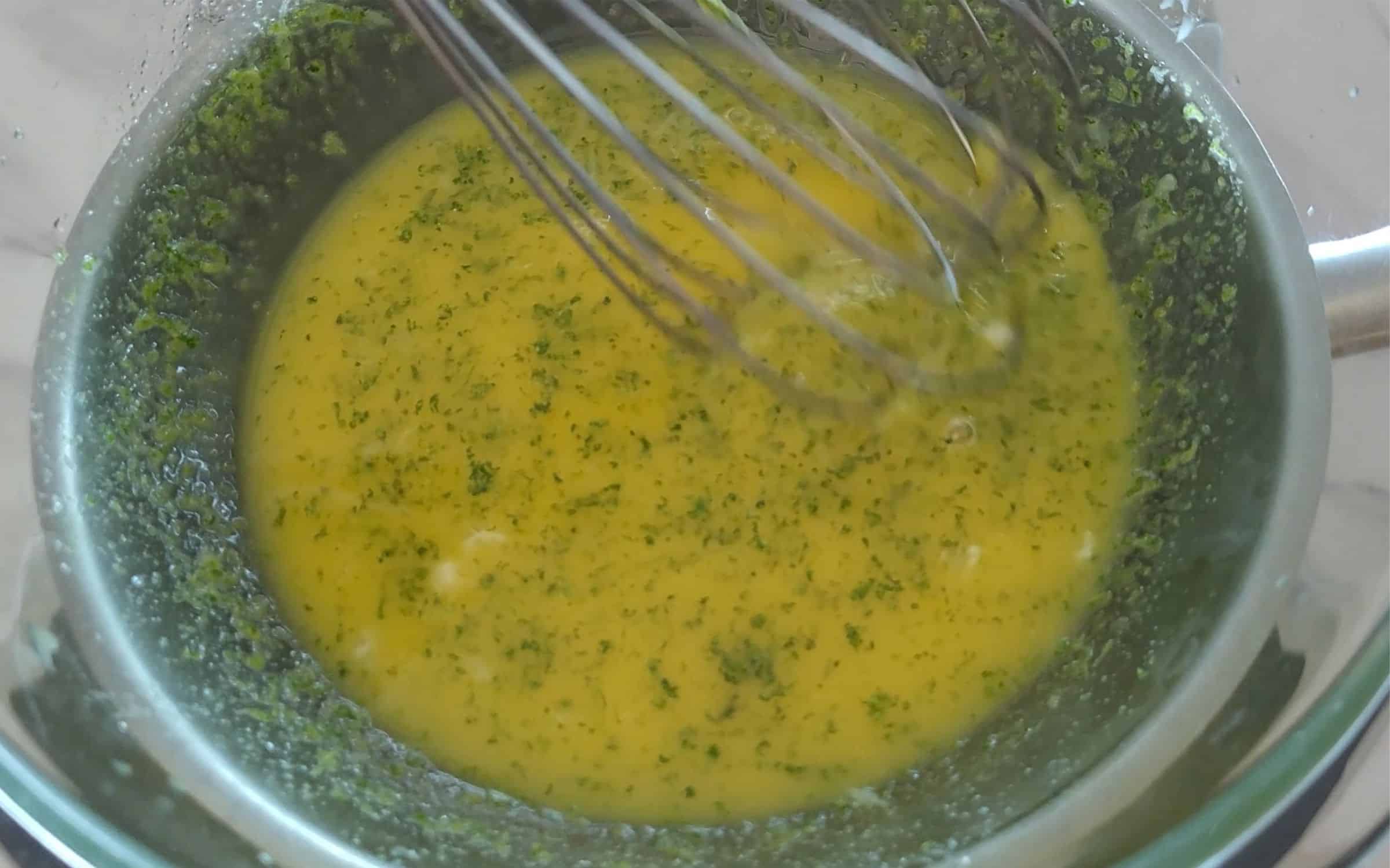 whisking together ingredients over a double boiler