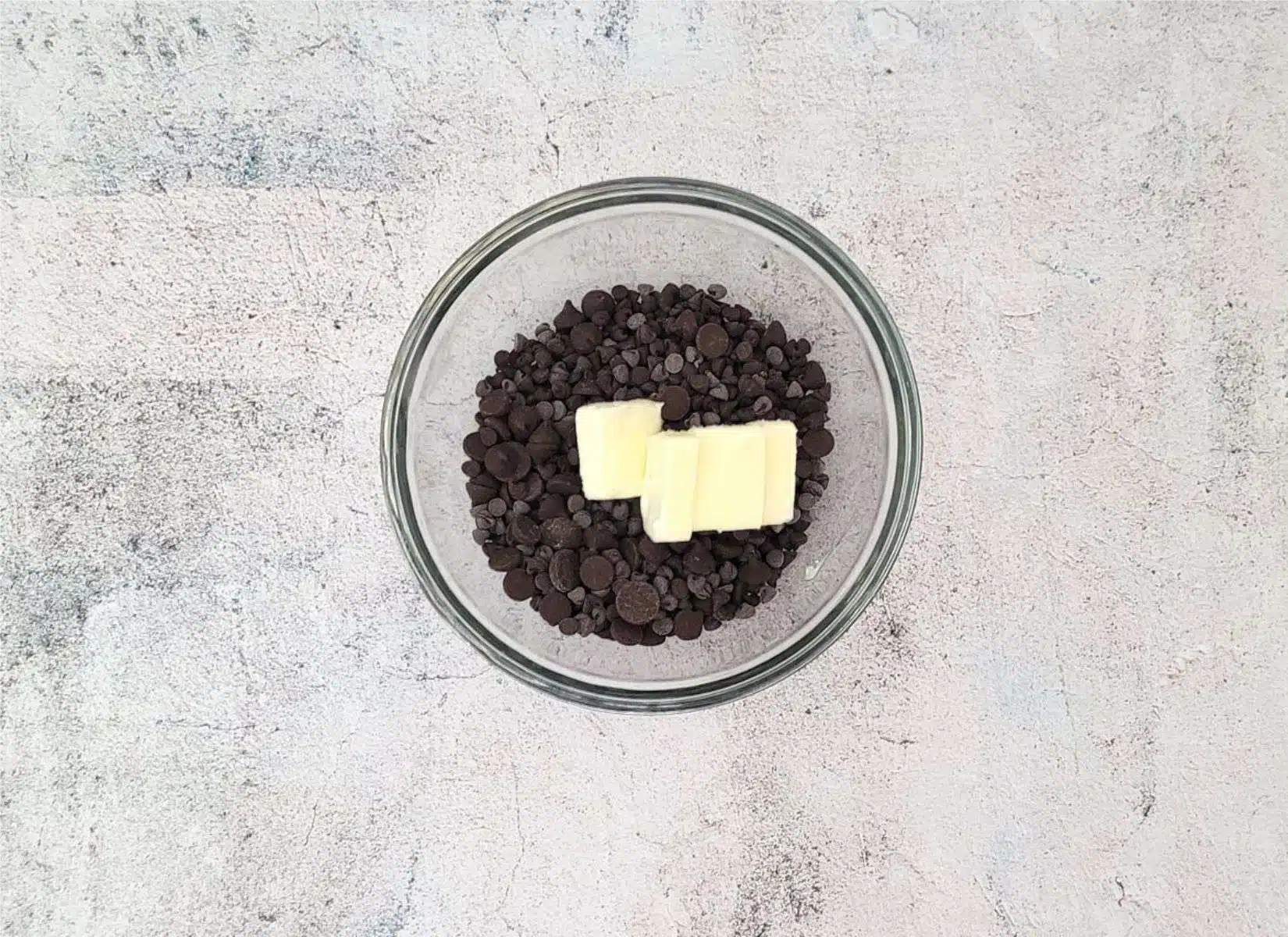 butter and chocolate chips in a glass bowl