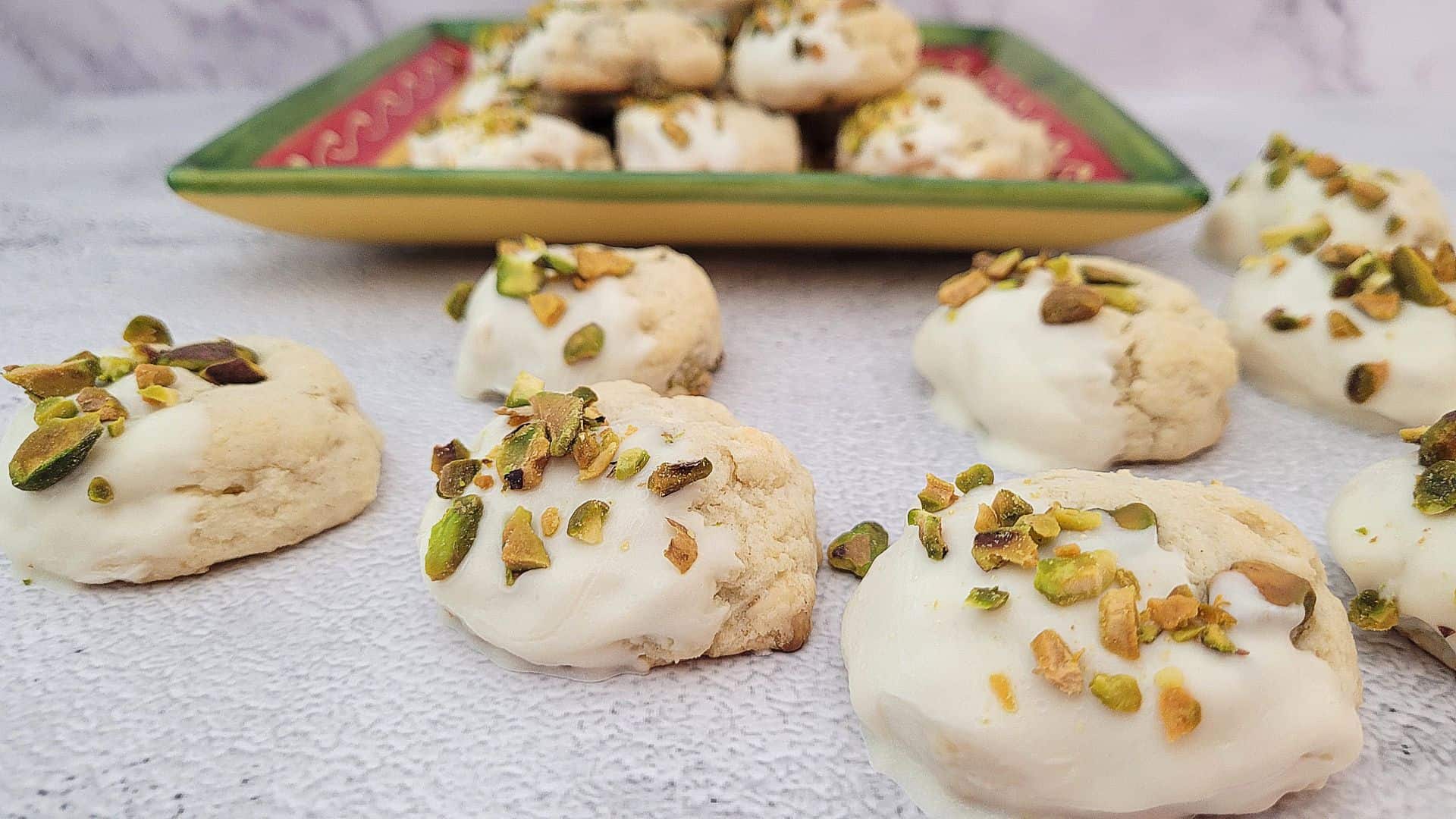 pistachio cookies on a countertop and some in a serving dish
