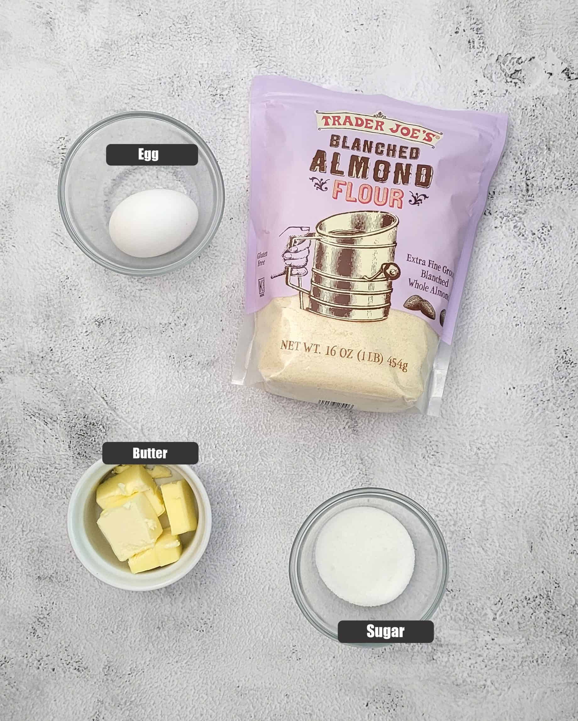 ingredients needed to make almond flour pie crust including almond flour, butter, sugar and an egg