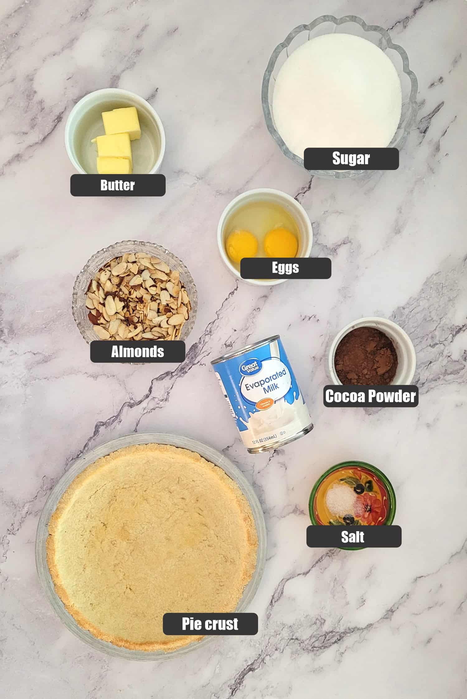 ingredients needed to make pie including pie crust, salt, cocoa powder, evaporated milk, eggs and butter