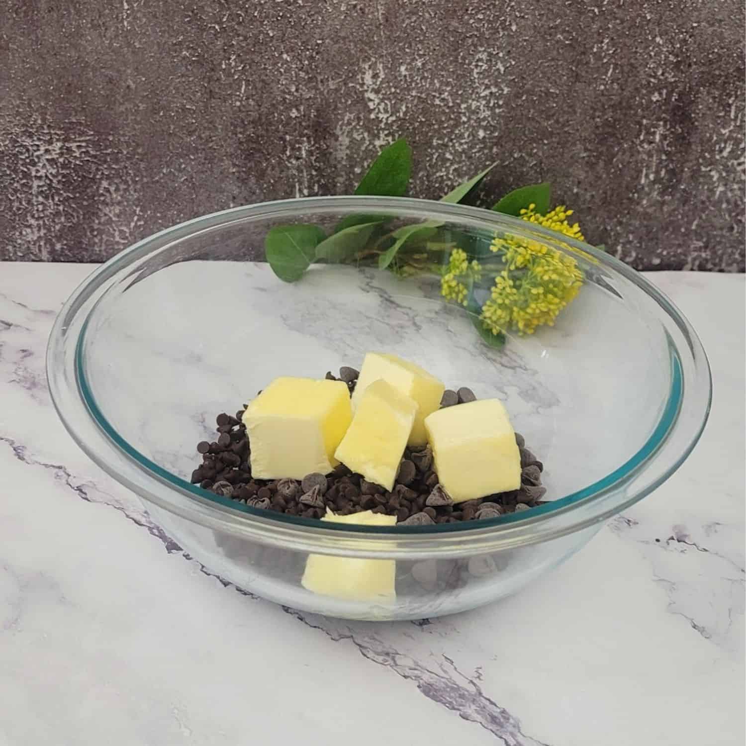 butter and chocolate combined in a glass mixing bowl