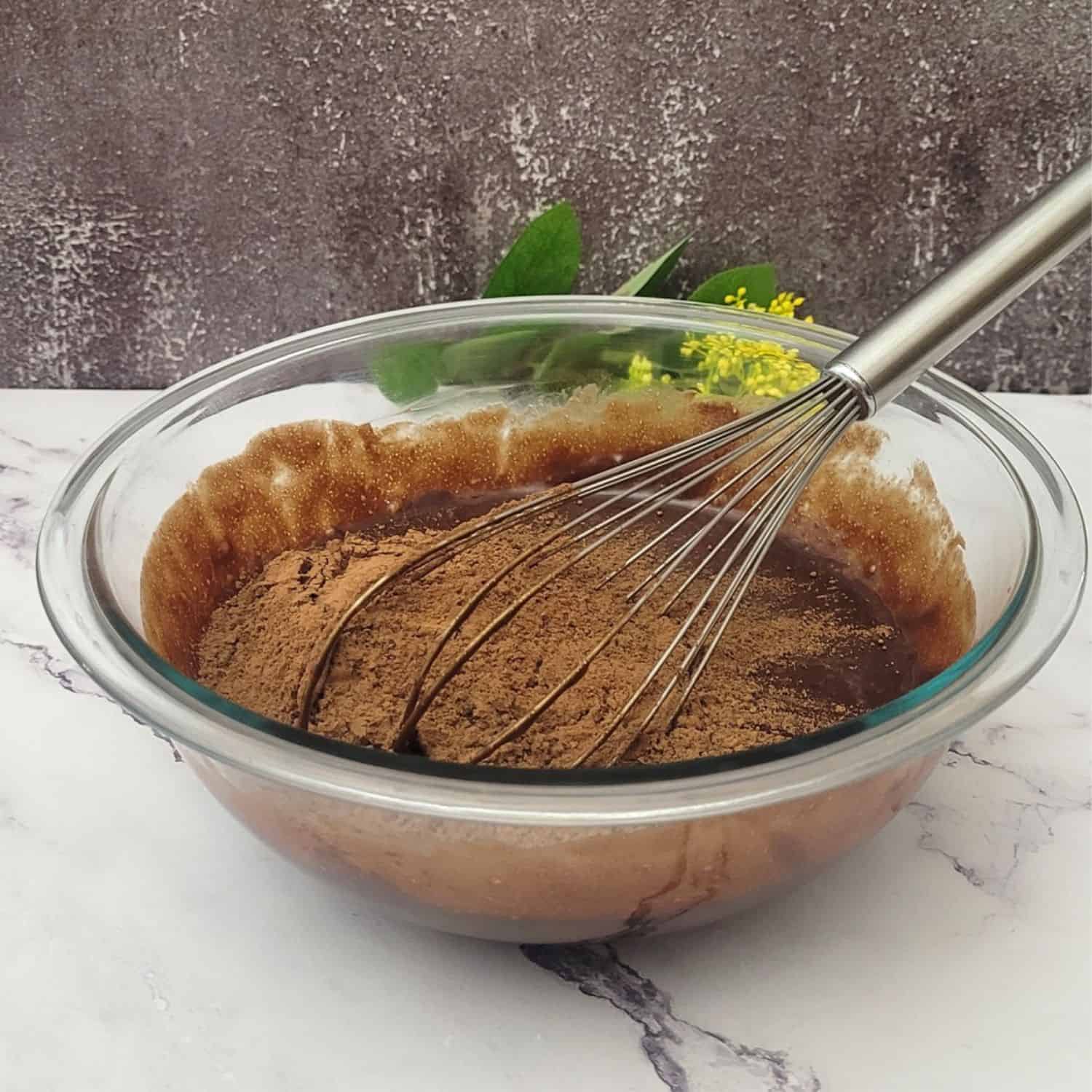 cocoa powdered added to cake batter bowl