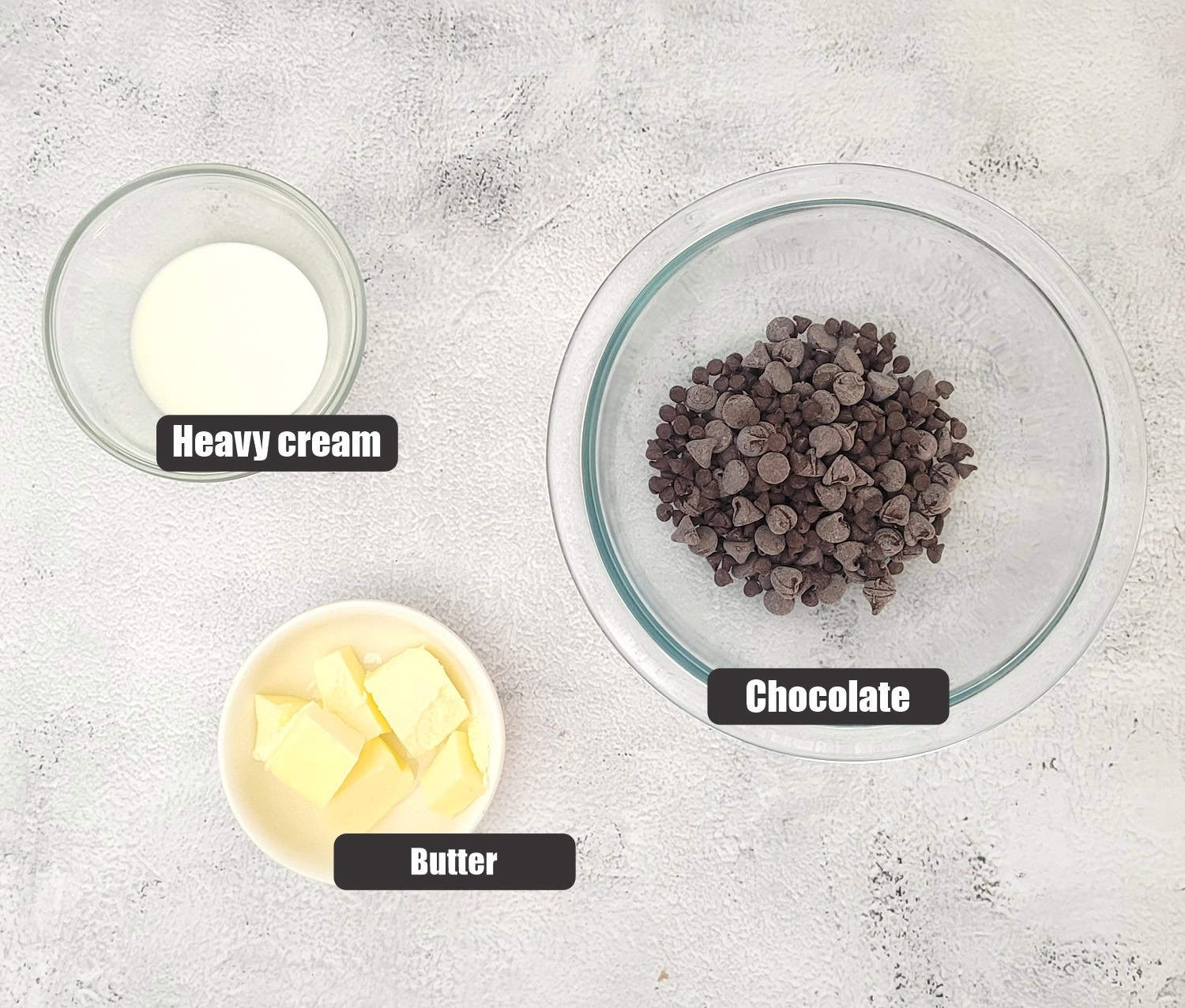 ingredients needed to make ganache topping for cake including butter, chocolate and heavy cream