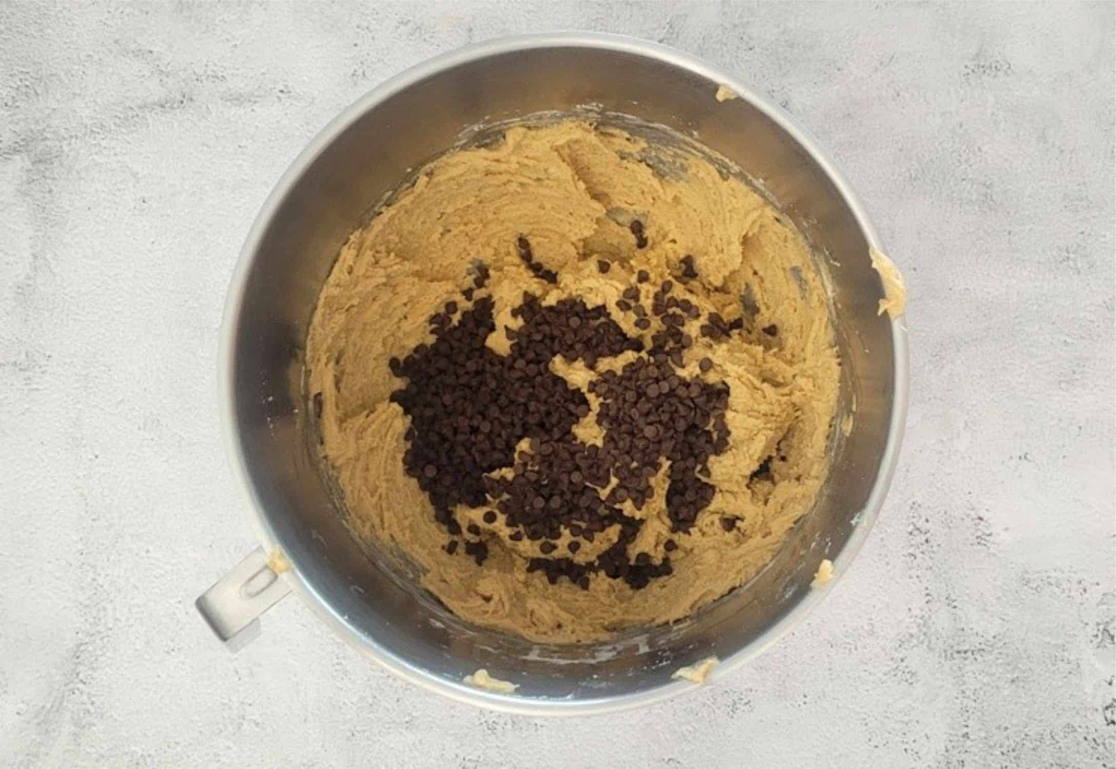 mini chocolate chips added to mixing bowl for final step in making gluten free peanut butter cookies