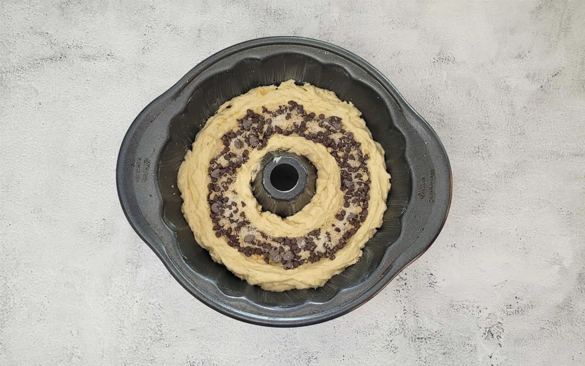 create a tunnel in the cake batter and add chocolate and banana slices for filling