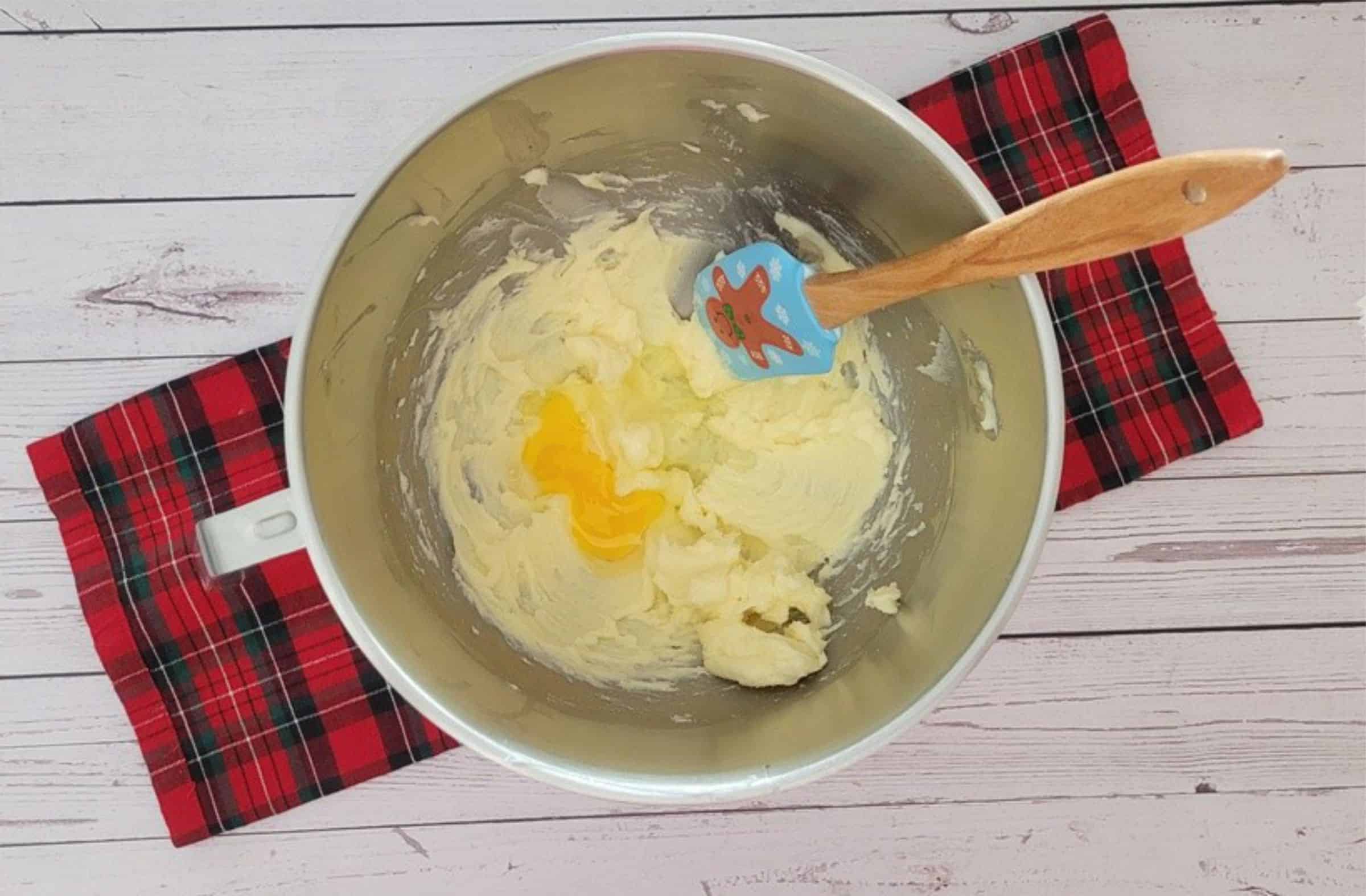 egg added to mixing bowl to make cookie dough