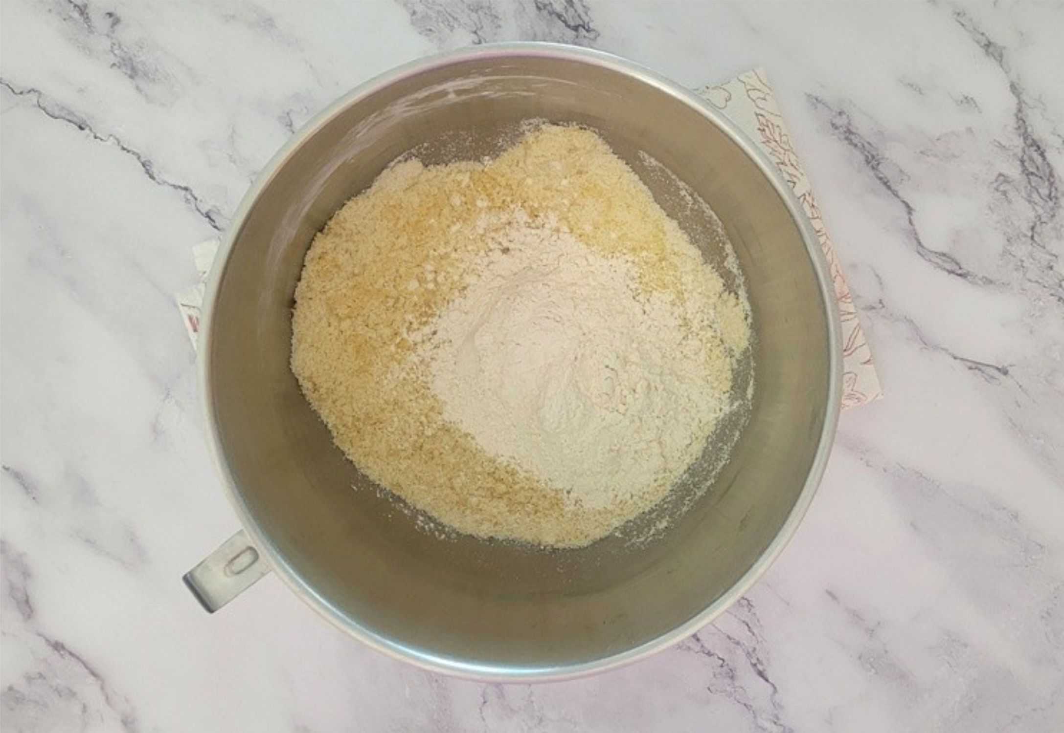 flour added to mixing bowl with almond paste and sugars