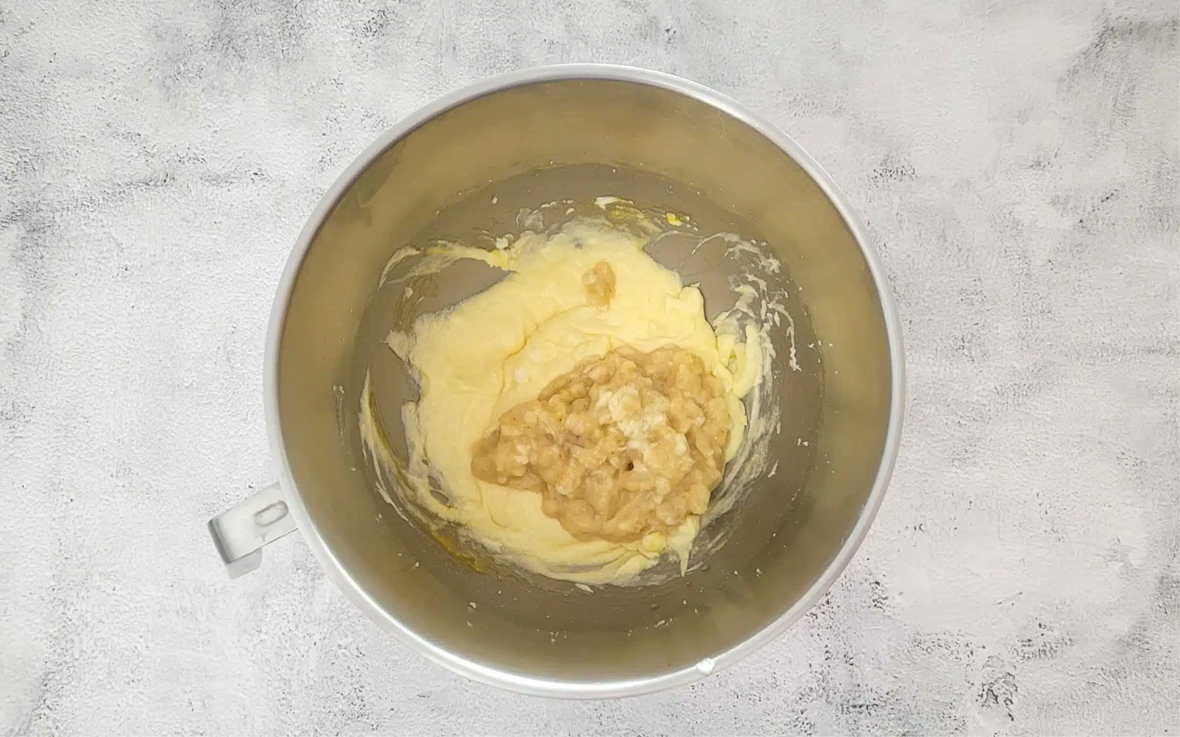 add mashed bananas to the mixing bowl to make cake batter