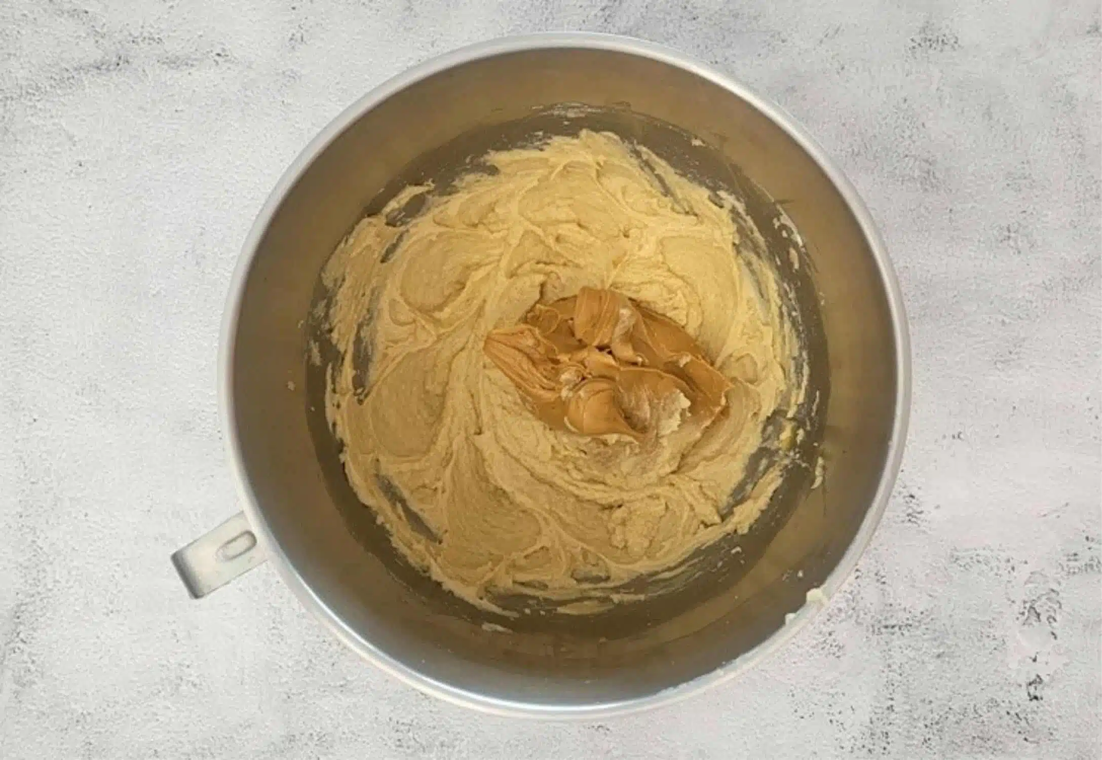 peanut butter added to mixing bowl to make cookie dough