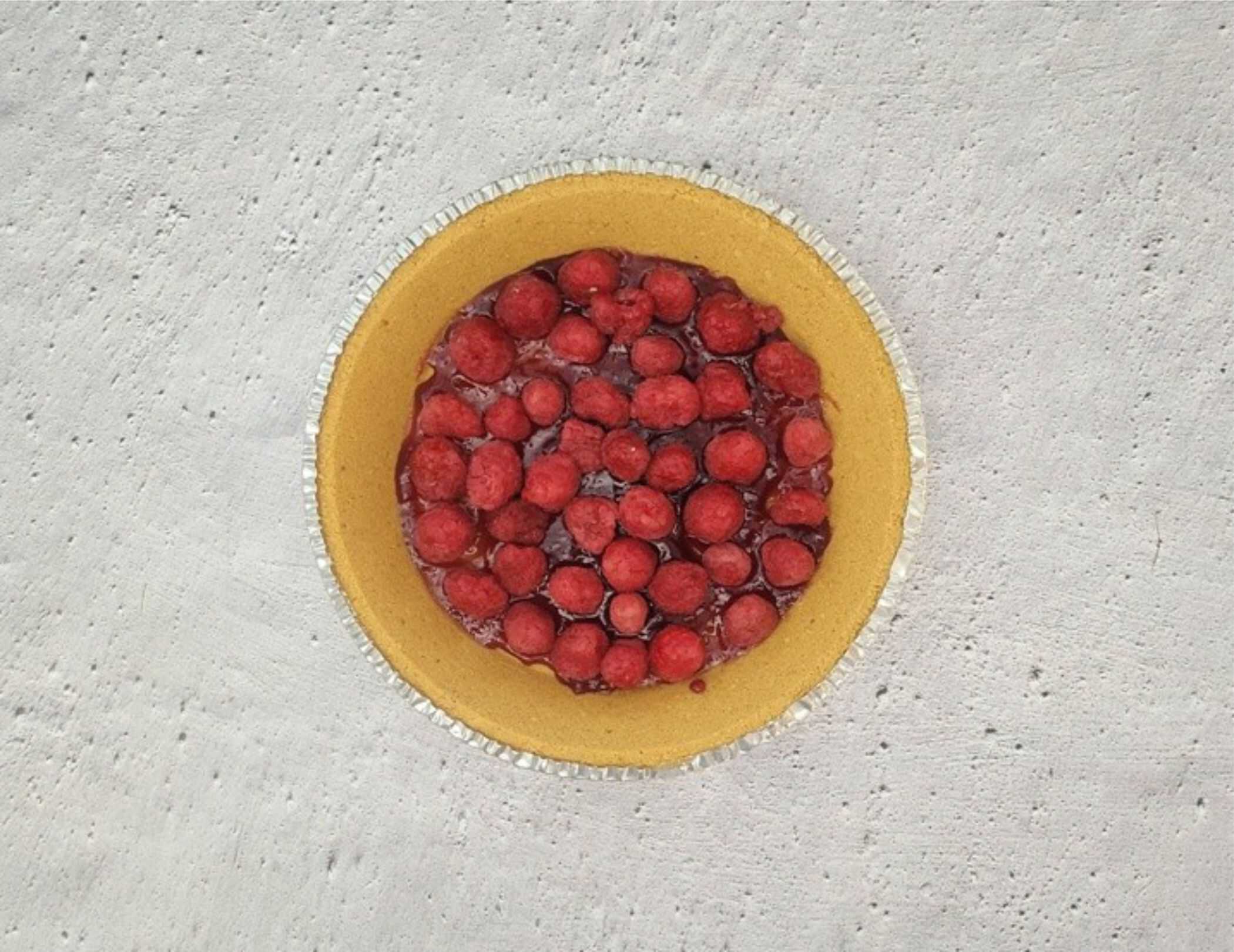 raspberry jam and fresh raspberries in a graham cracker crust