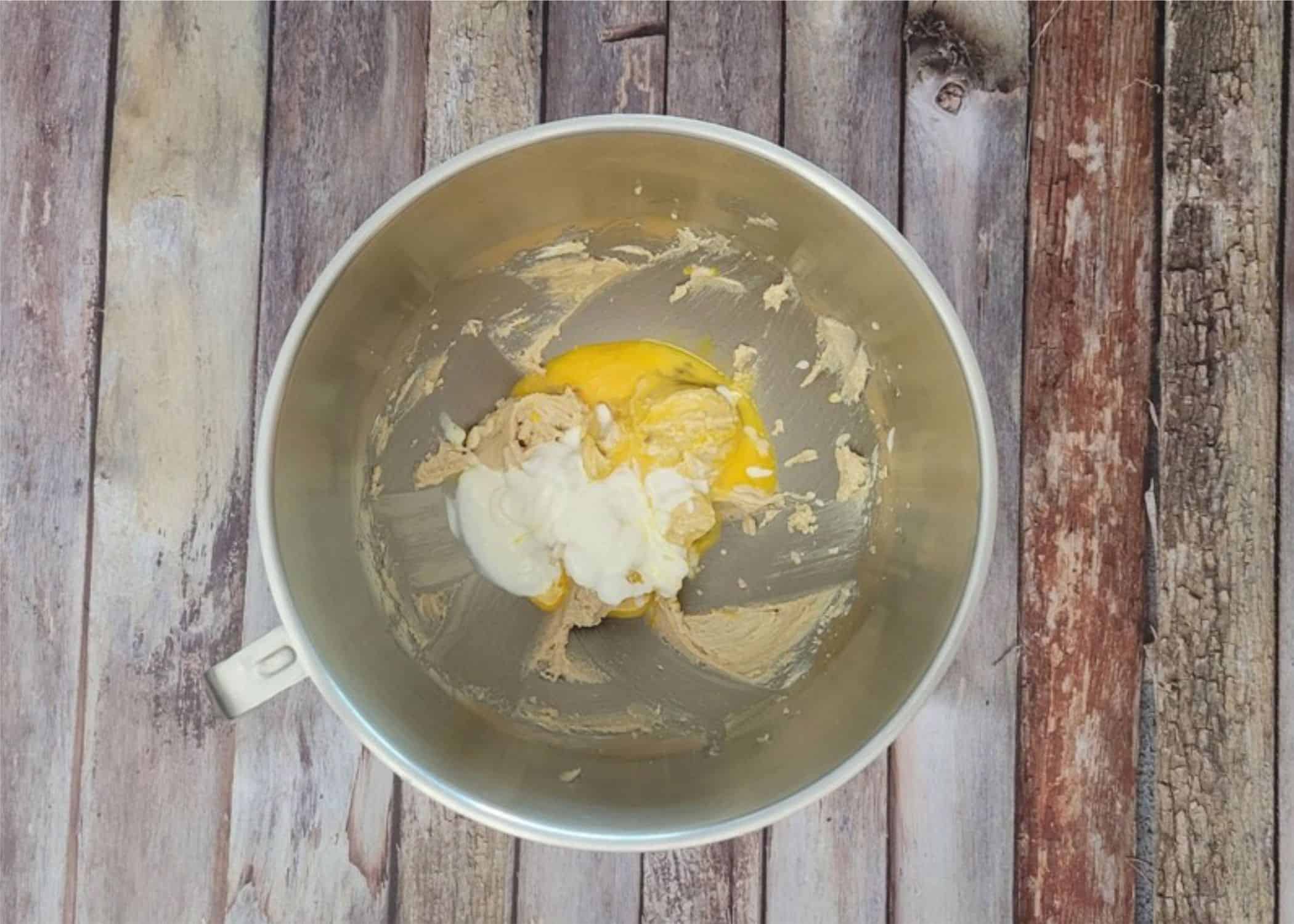 add room temperature sour cream and eggs to mixing bowl for cookie dough