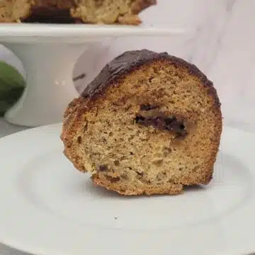 close up view of a slice of banana cake with a chocolate tunnel filling