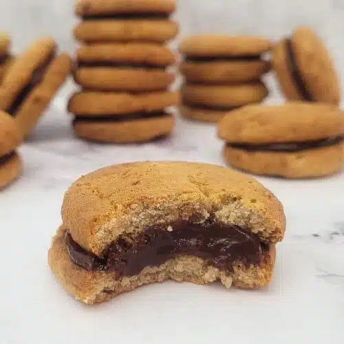 banana chocolate cookie and one with a bite taken to show fudgy filling