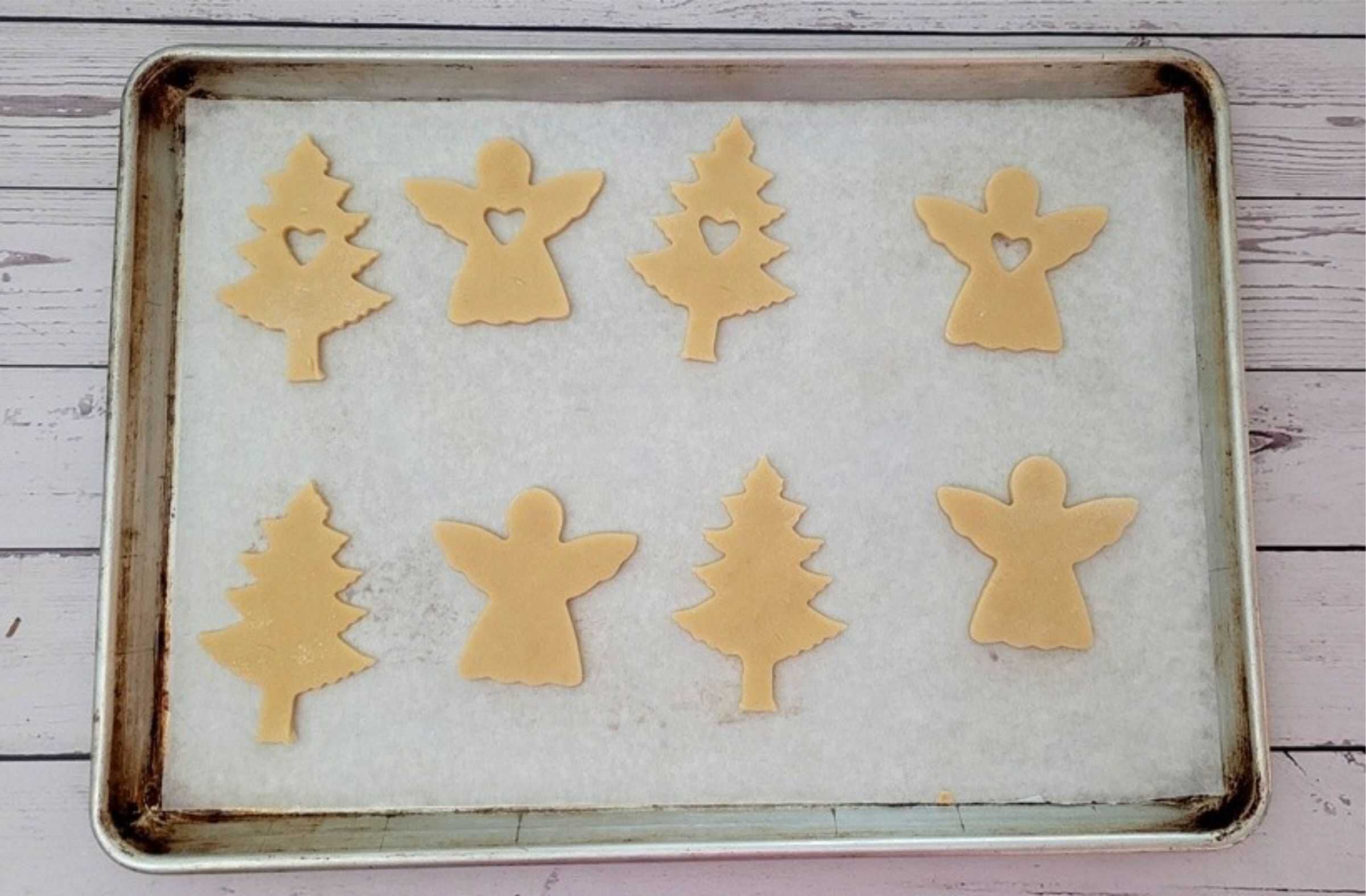 cut out holiday Linzer cookies on a sheet pan ready for baking