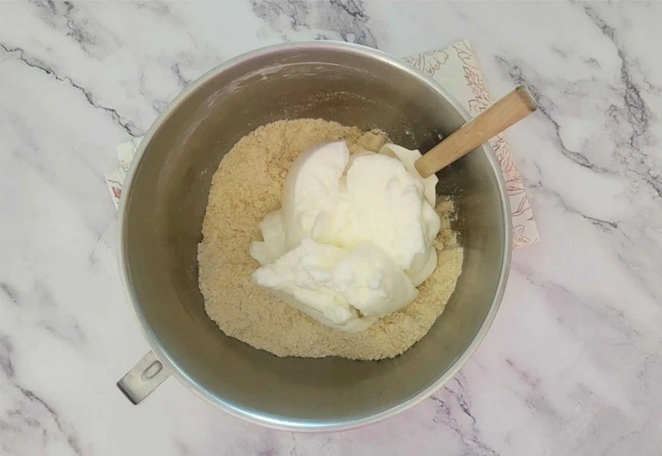 folding whipped egg whites into almond paste mixture