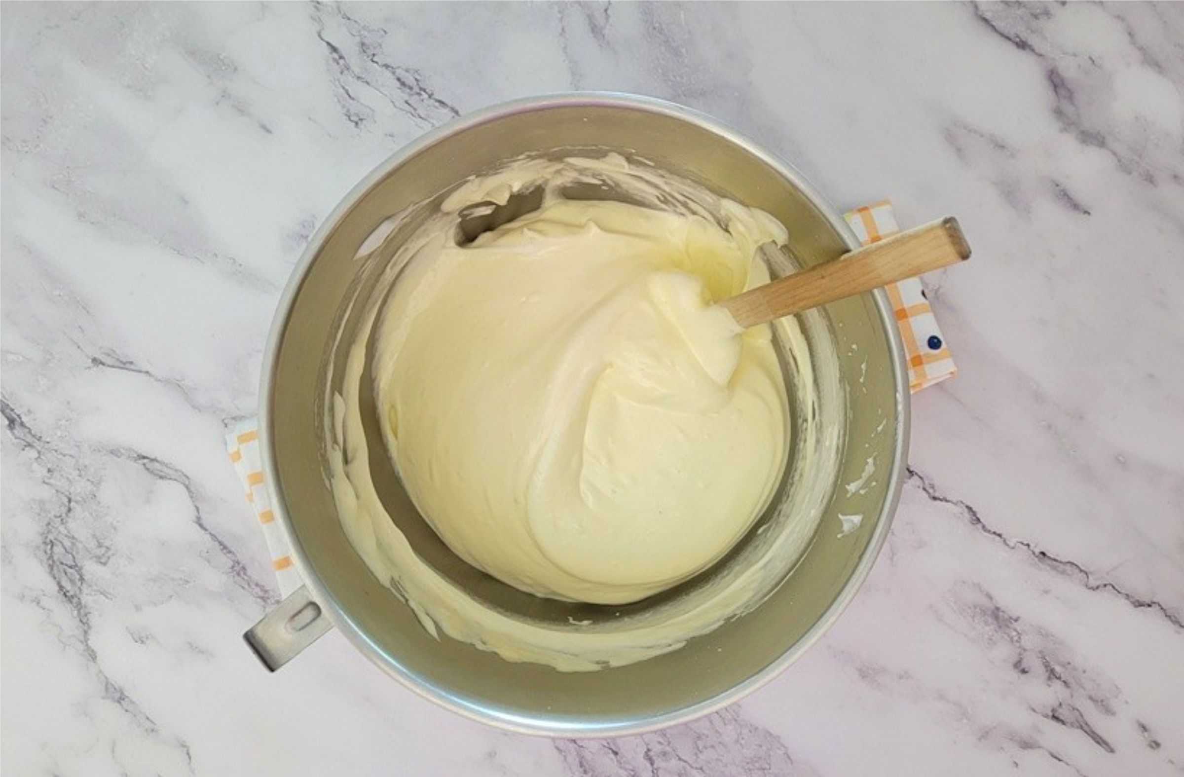 whipped egg yolks being folded into whipped egg whites