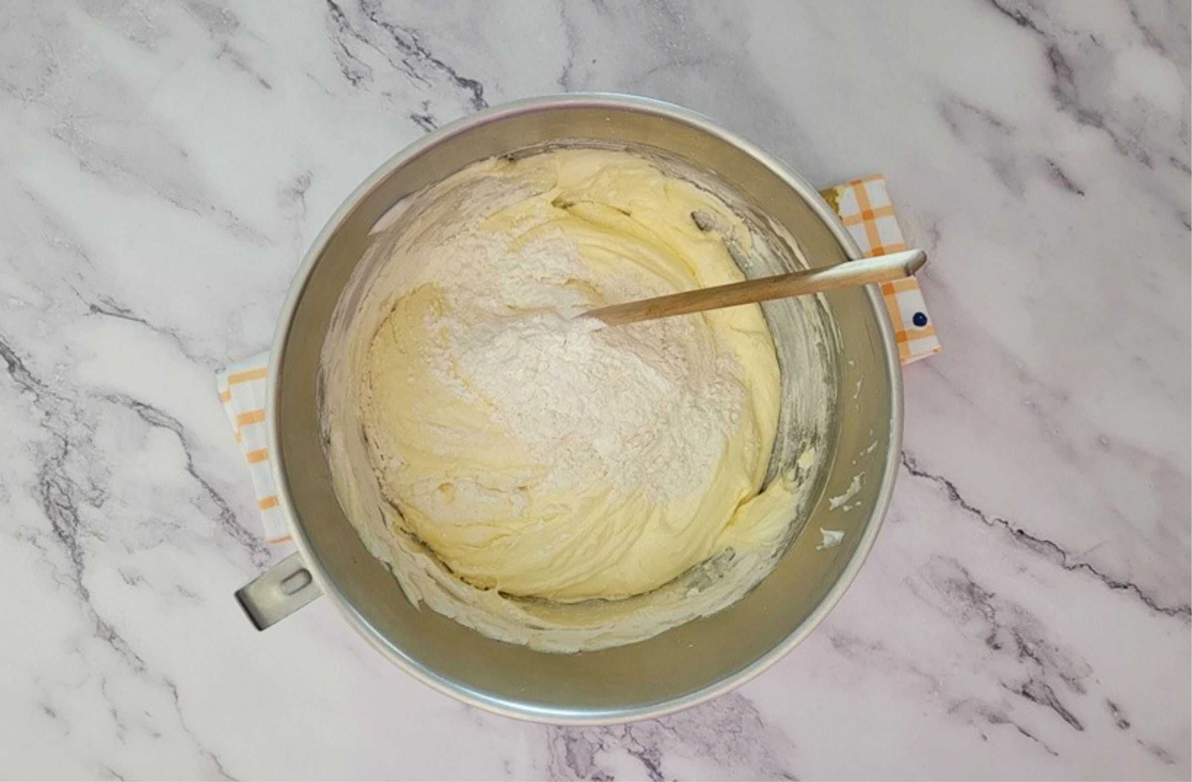 second addition of flour and cornstarch being folded into egg foam to make sponge cake