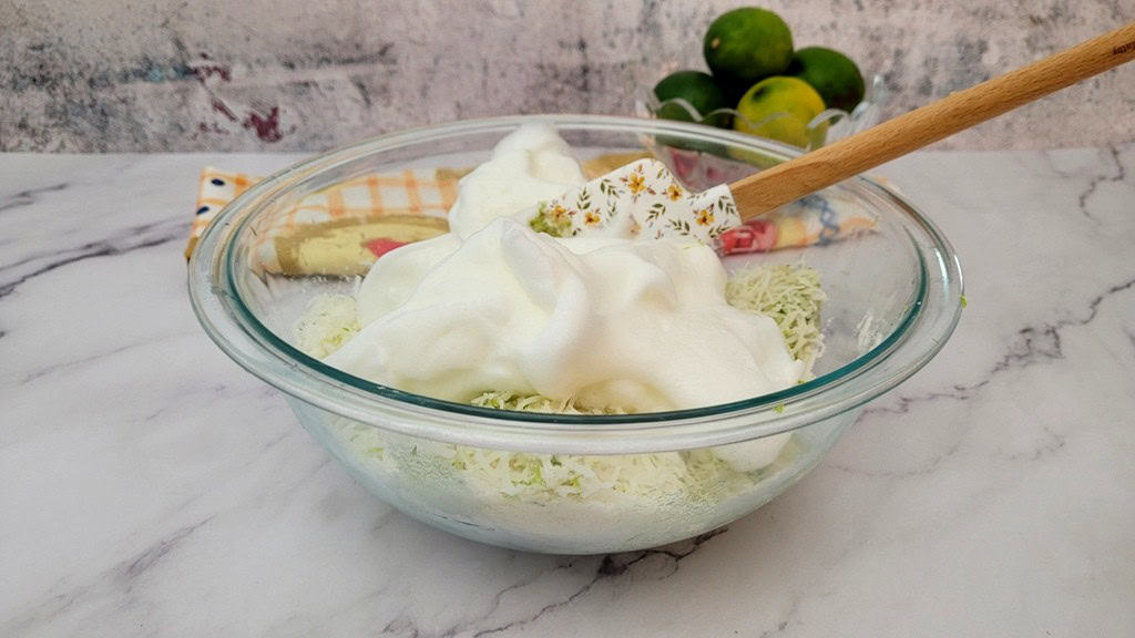 whipped egg whites being folded into other ingredients to make coconut lime macaroons