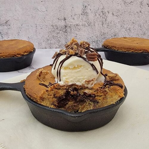 peanut butter cup skillet cookie with a portion of the inside showing