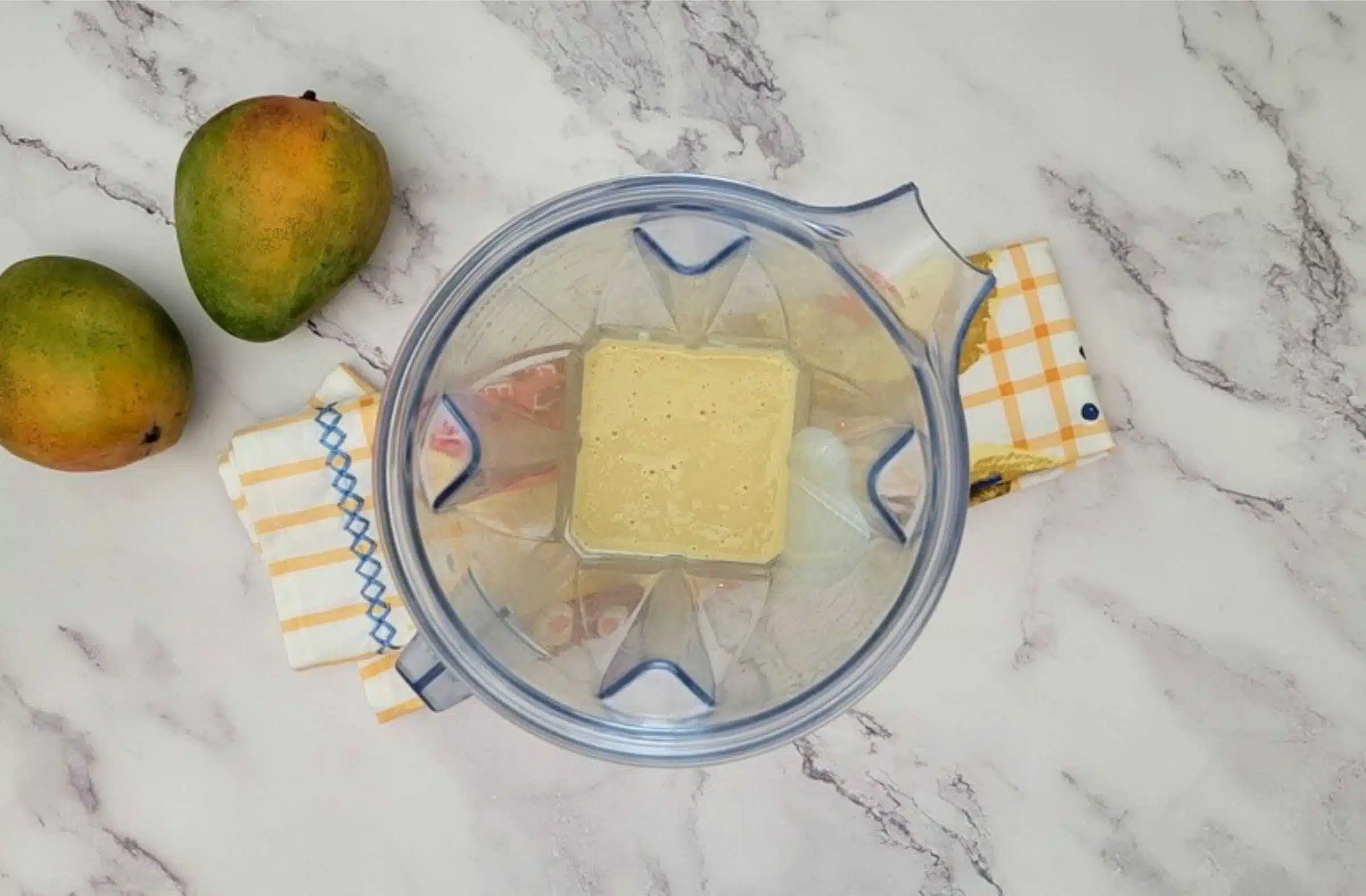 sweetened condensed milk, evaporated milk, cream and mango pureed together to make three milks for pouring over sponge cake