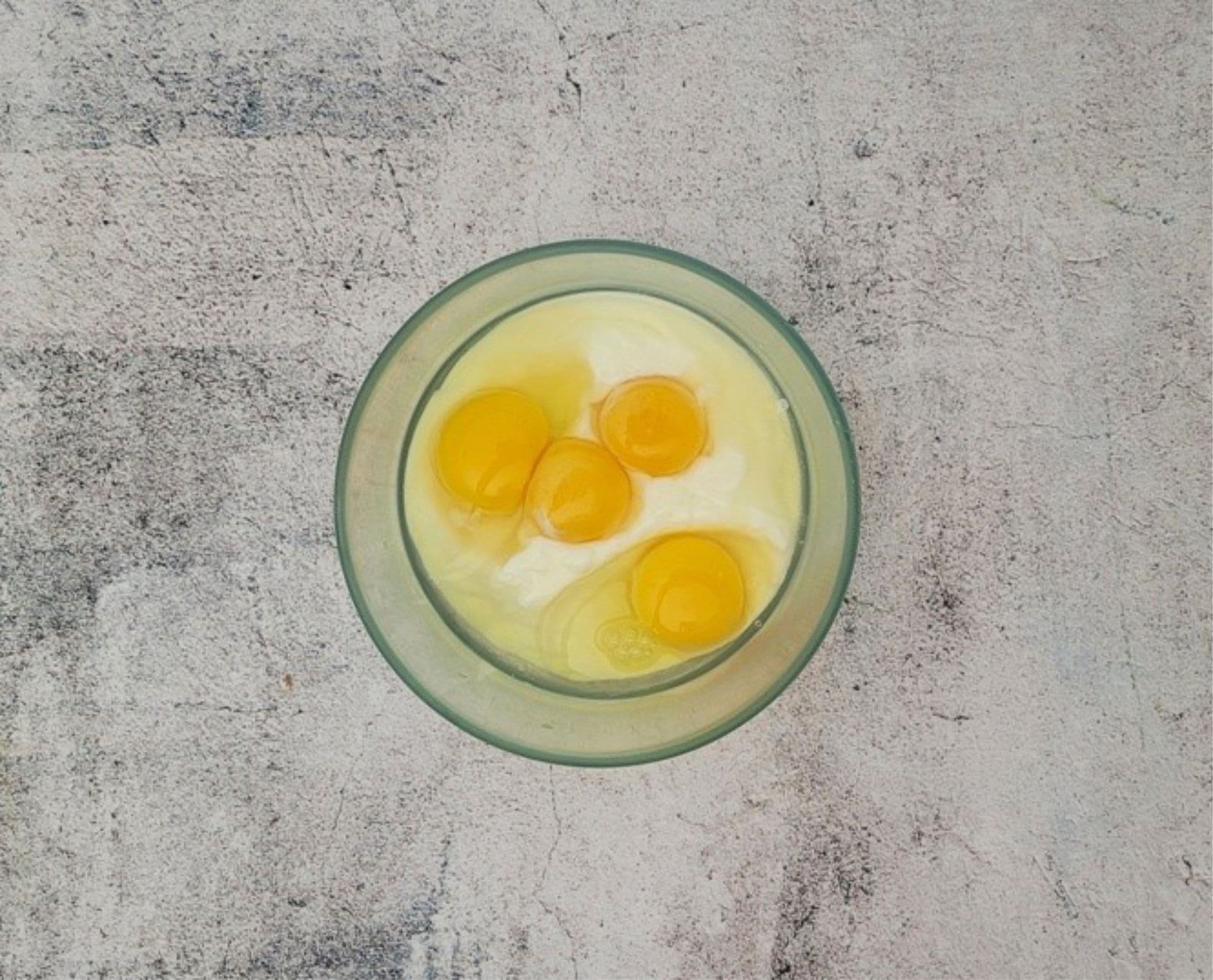 sour cream, eggs and egg yolks in a mixing bowl