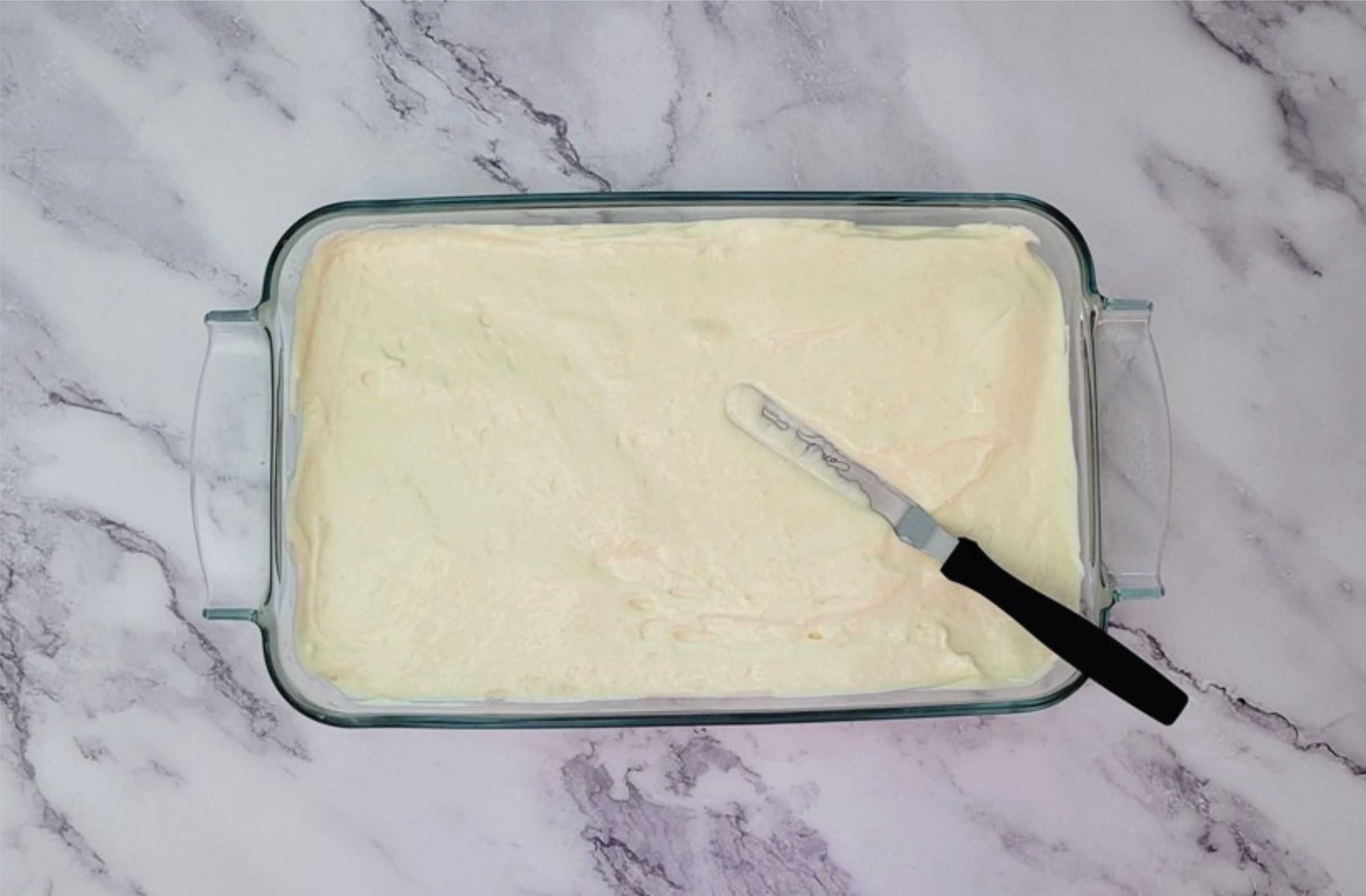 sponge cake batter poured into 9" x 13" glass baking pan