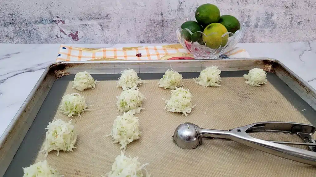 macaroons scooped onto a baking sheet