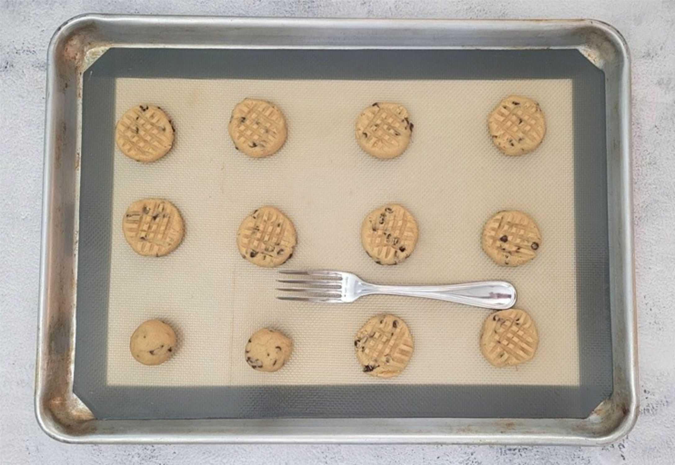 GF peanut butter cookies scooped onto a baking sheet before baking