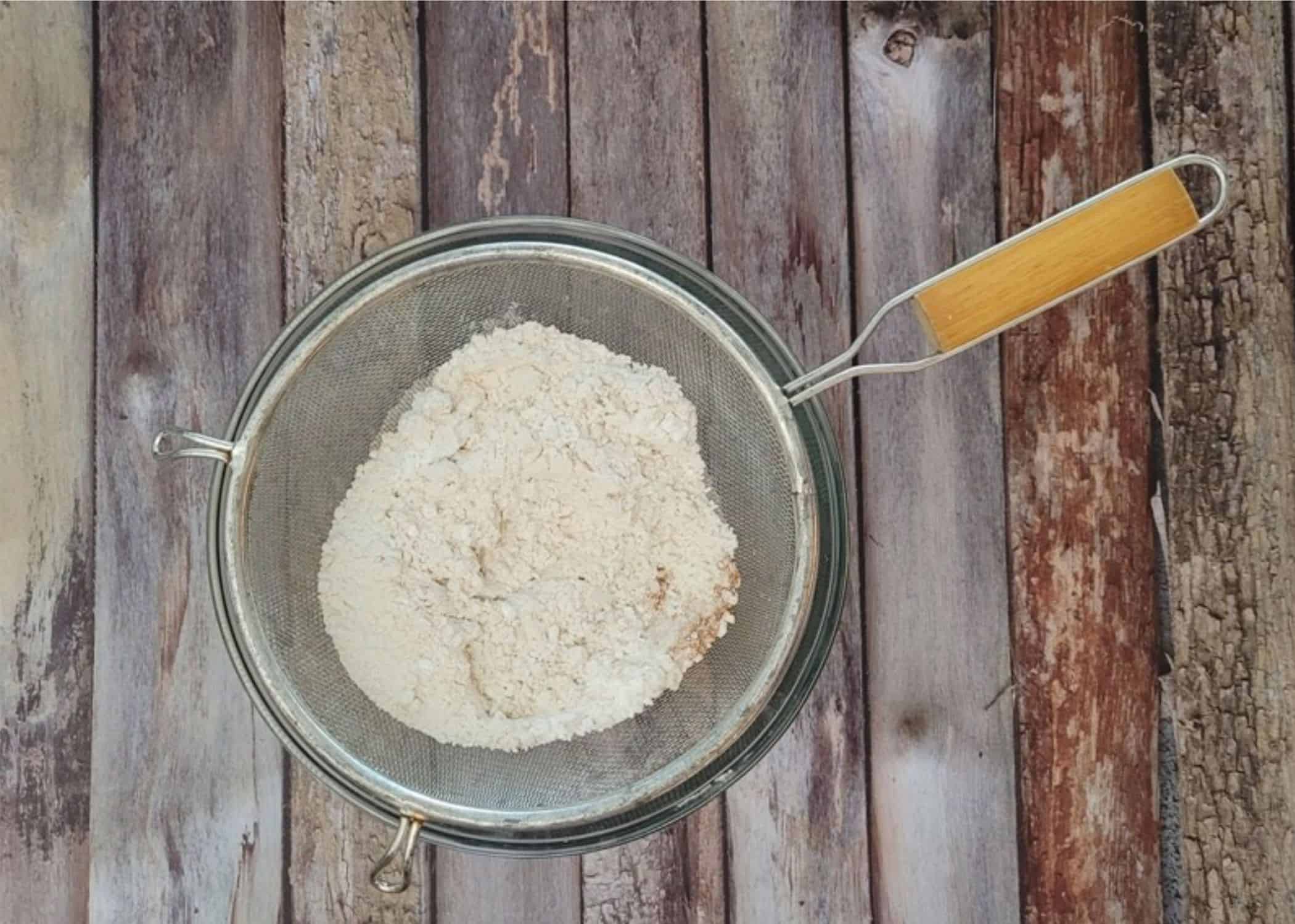 flour, cornstarch, baking soda and ground cinnamon in a sieve