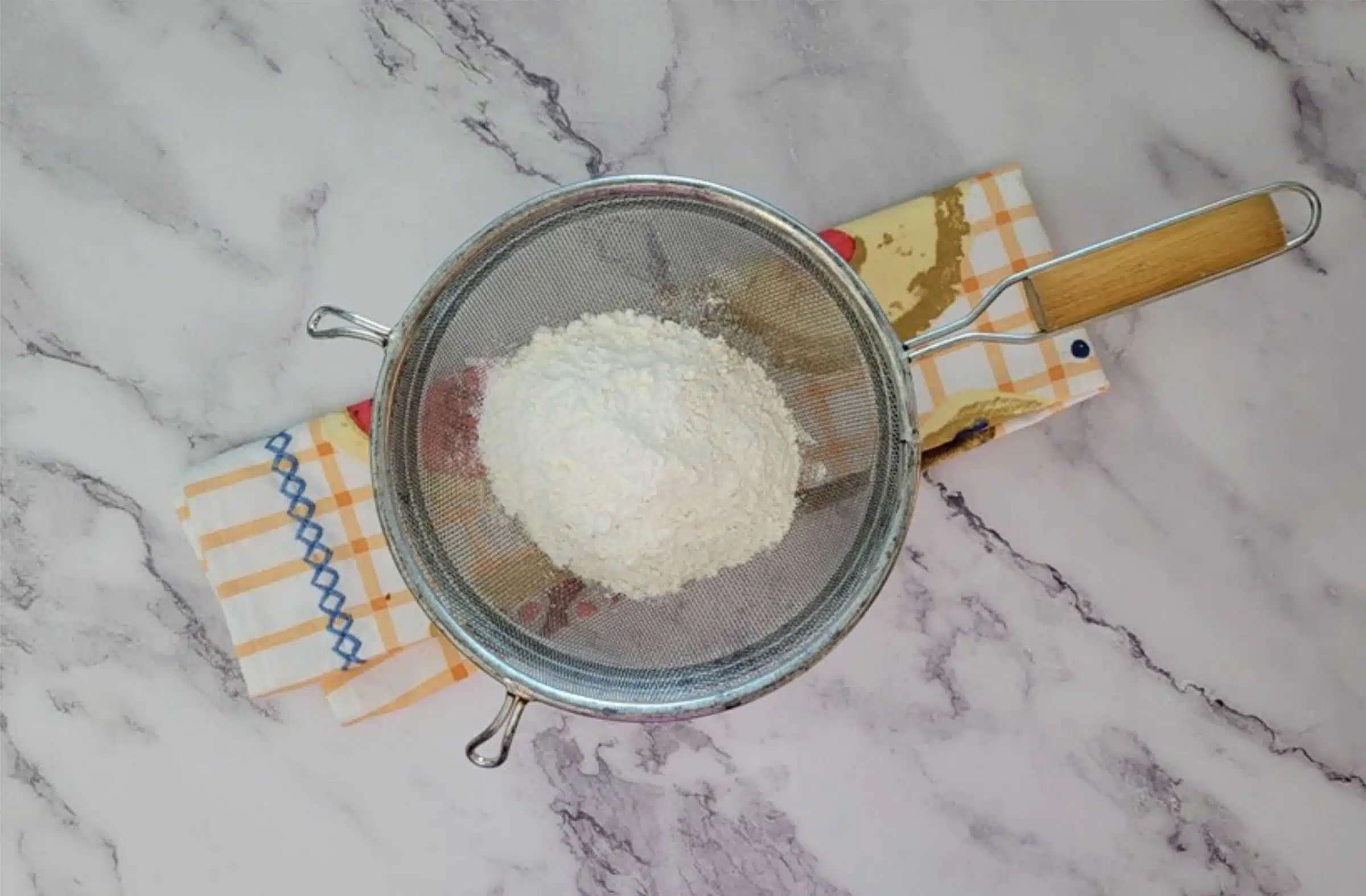 cornstarch and flour in a mesh sieve to sift together