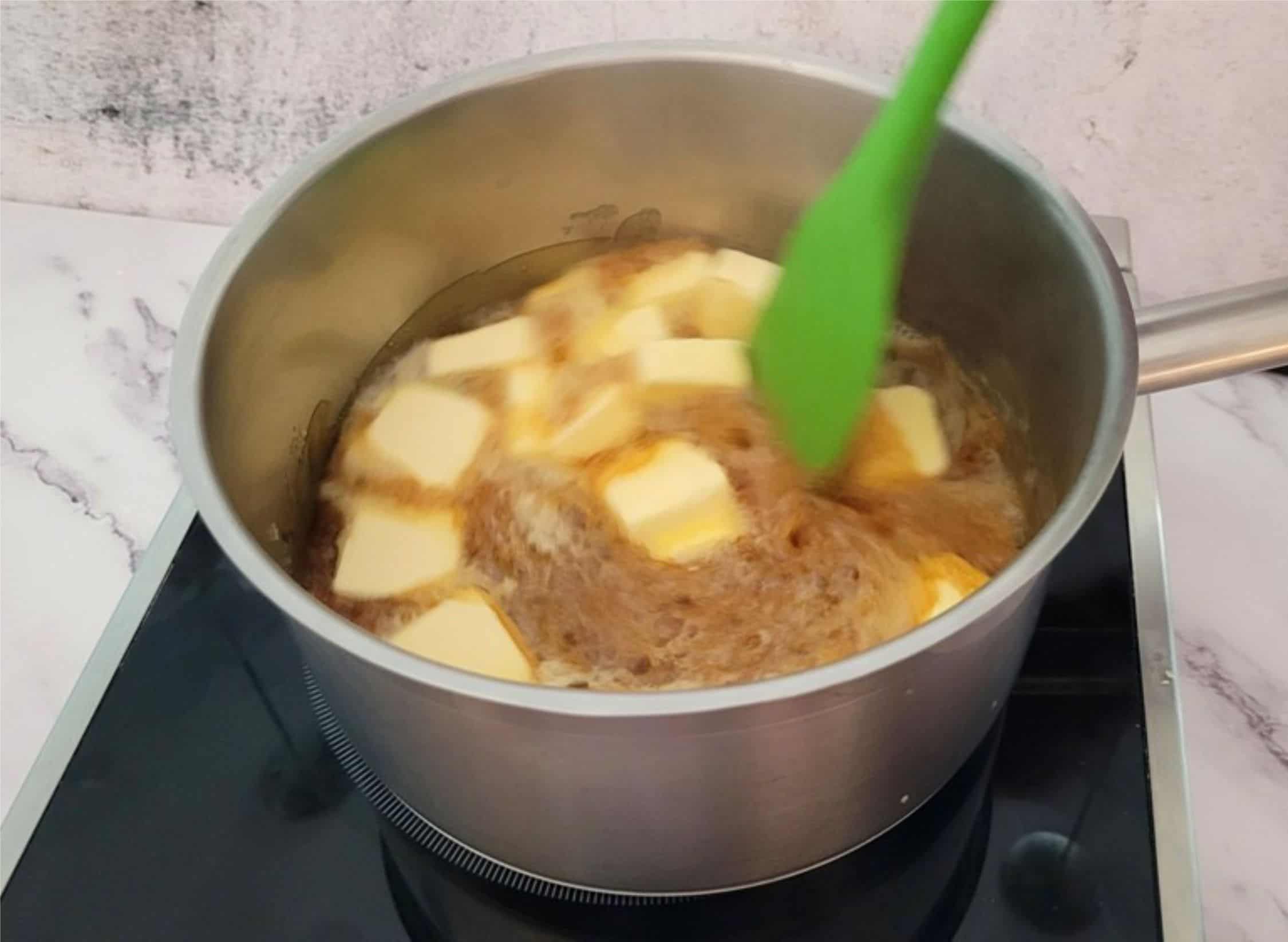 adding butter to caramel