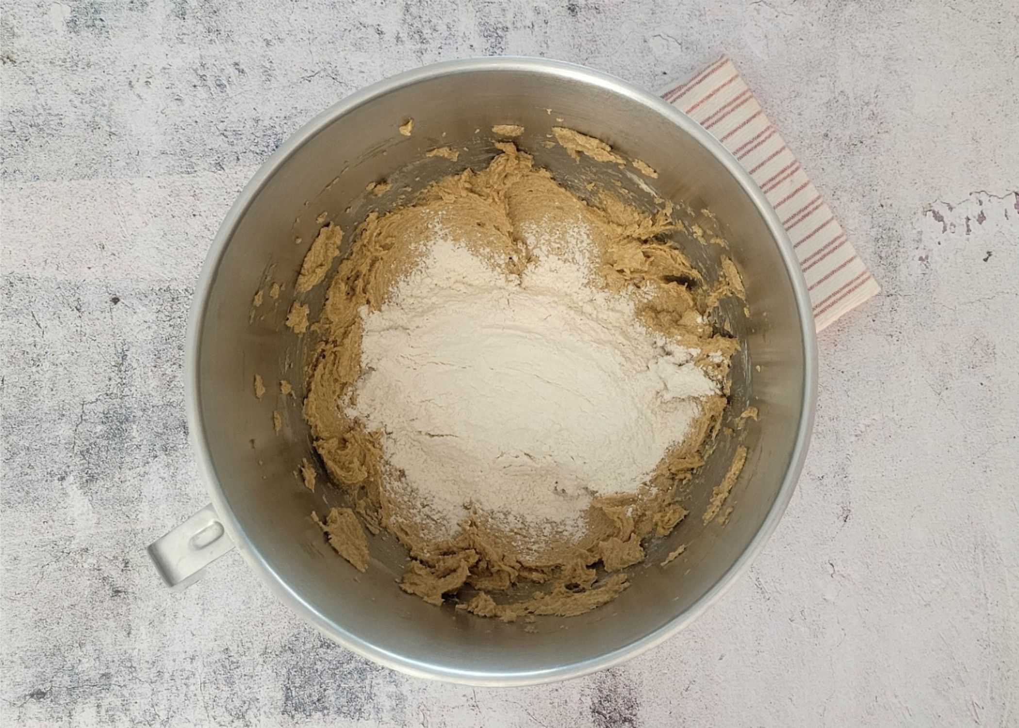 dry ingredients added to bowl with butter and sugar mixed together