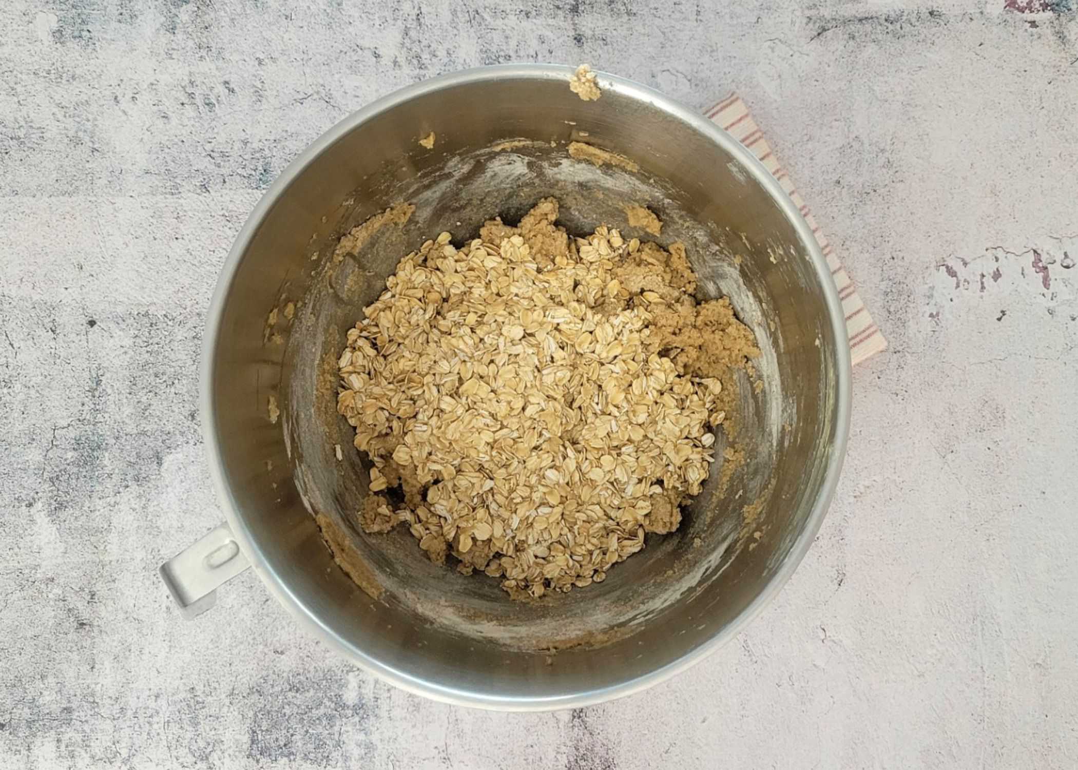 oatmeal added to mixing bowl to make cookie bar dough